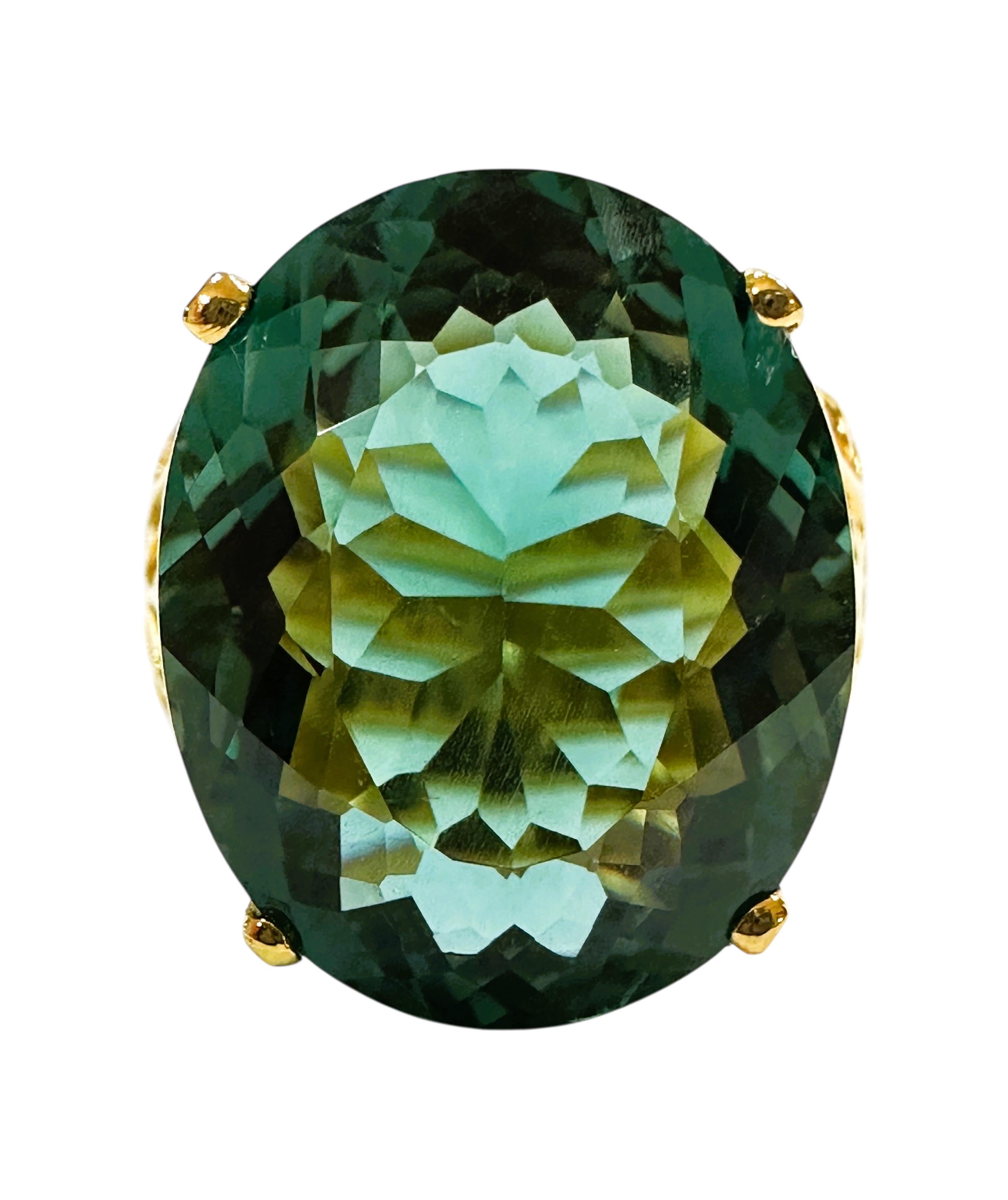This ring is just a beautiful color of green.  The ring is a size 6.5. The stone is from Africa.  It is a beautiful fancy cut oval stone and is 16 carats.  It is a very high quality stone.  It measures 19 x 15.5 mm.   It is set in a gorgeous diamond