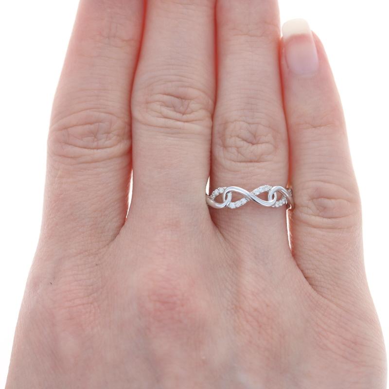 Celebrate the beauty of everlasting love with this gorgeous ring! Featuring a symbolic infinity motif, this NEW band showcases sparkling diamonds set in 14k white gold. 

This ring is a size 6 1/4 - 6 1/2, but it can be re-sized up 2 sizes for a $35