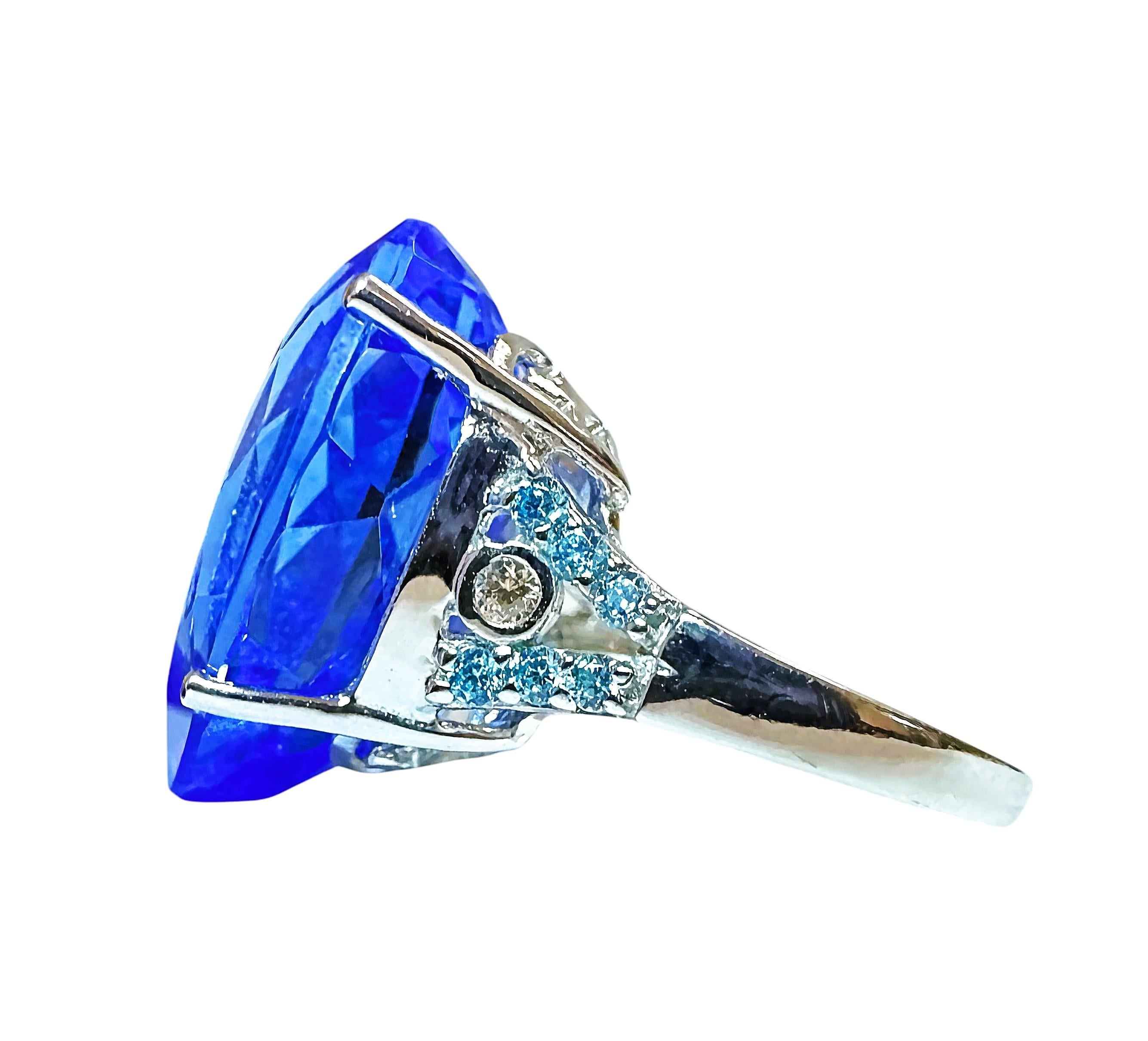 I love the color of this stone.  It is just so brilliant.  The ring is a size 6.25.  The stone is from Africa and is just exquisite.  It is a fancy pear cut stone and is 17.0 Cts.   The main stone is 21 x 15 mm and has tiny diamond cut aqua blue