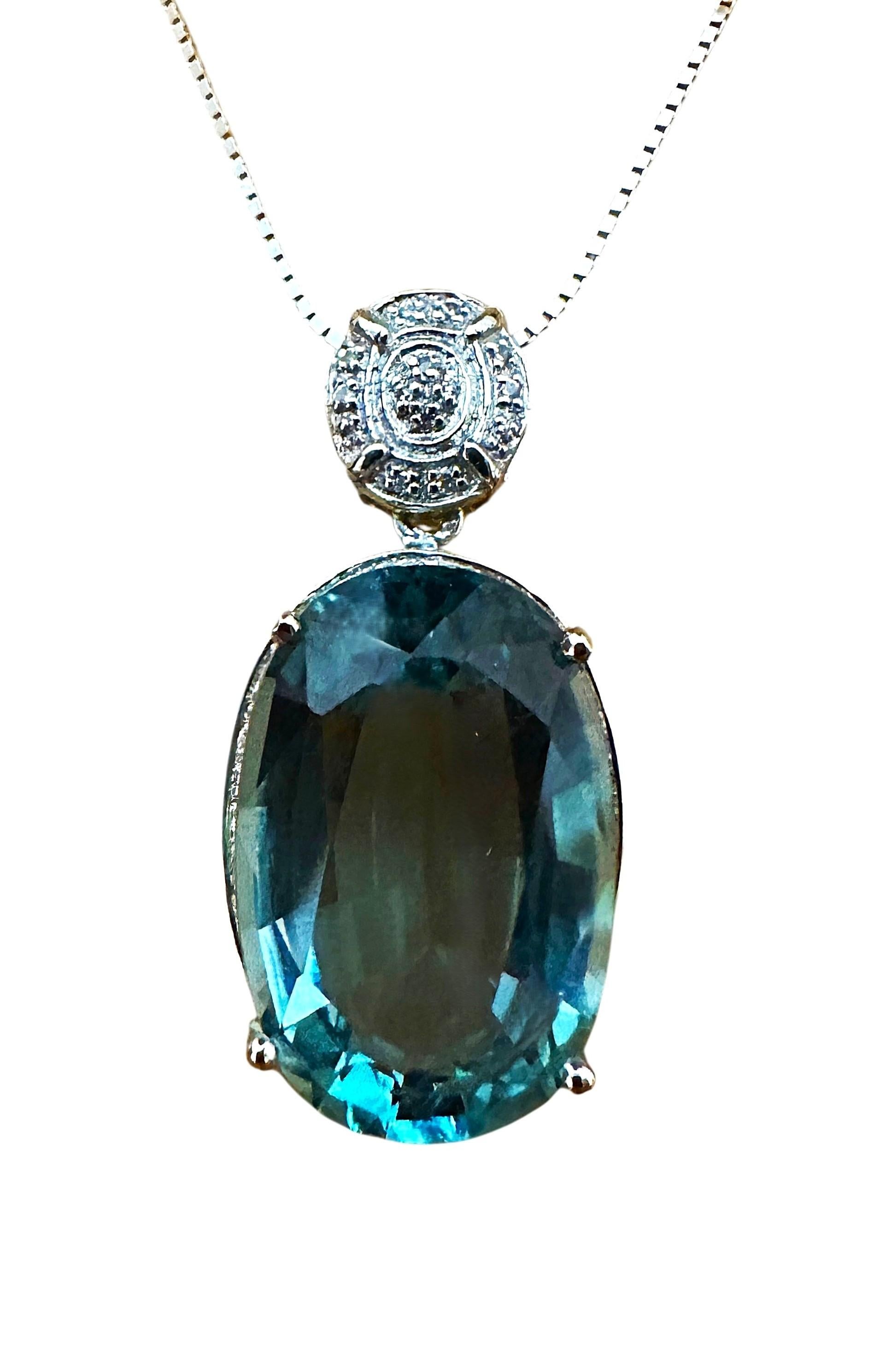 The stone is from Brazil and is just exquisite. The stone is an Oval cut Aquamarine and is 17.20 carats. It measures 21 x 14 mm and is surrounded by diamond cut white sapphires.  They are all placed in a sterling silver filigree setting.  It is on