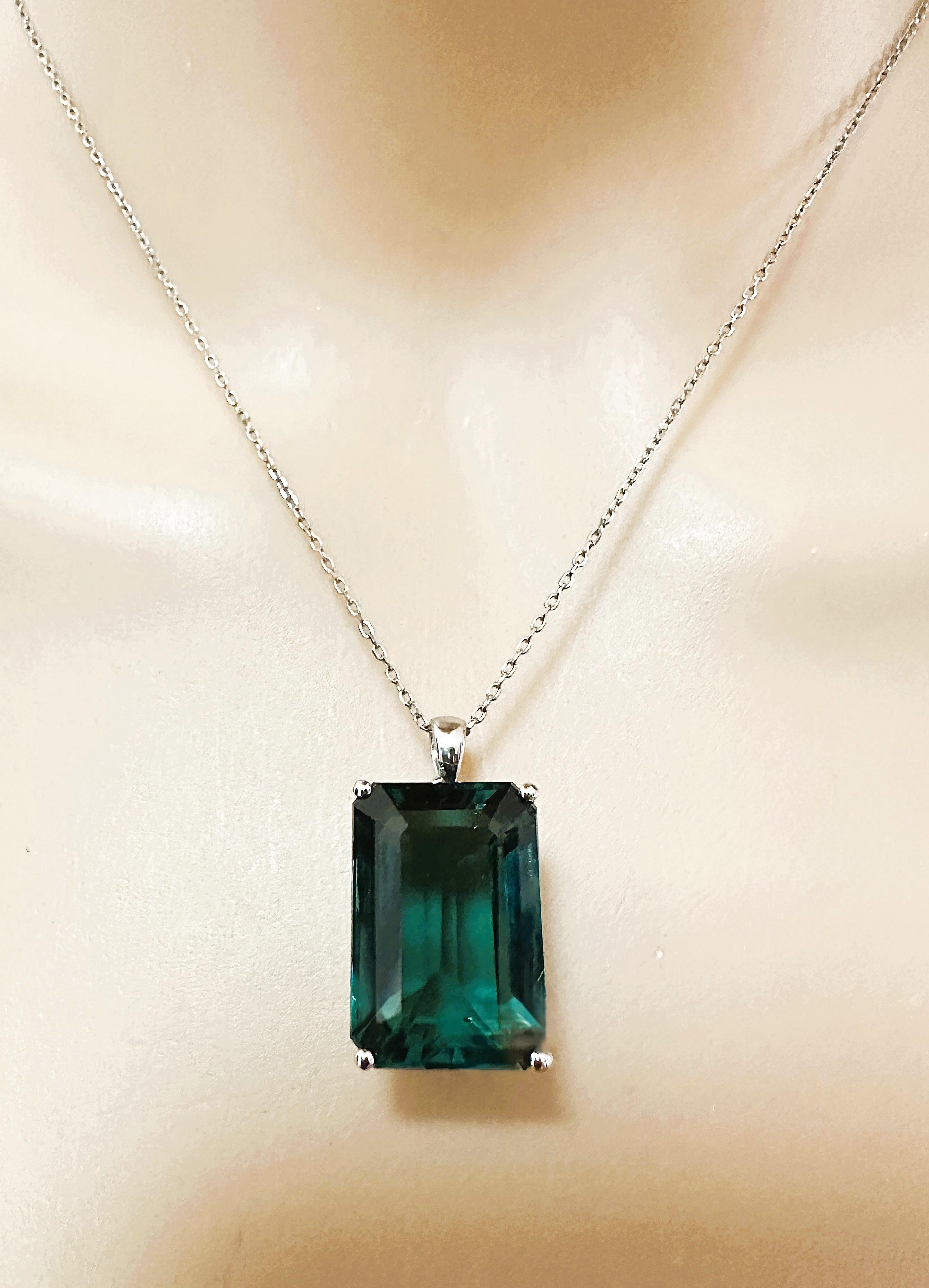 The stone is from Asfrica and is just exquisite. The stone is a deep green tourmaline and is 17.4 carats.  The stone is a baguette cut stone and measures 19 x 13.3 mm  It is placed in a beautiful sterling setting.  It is on a 925 Sterling Silver