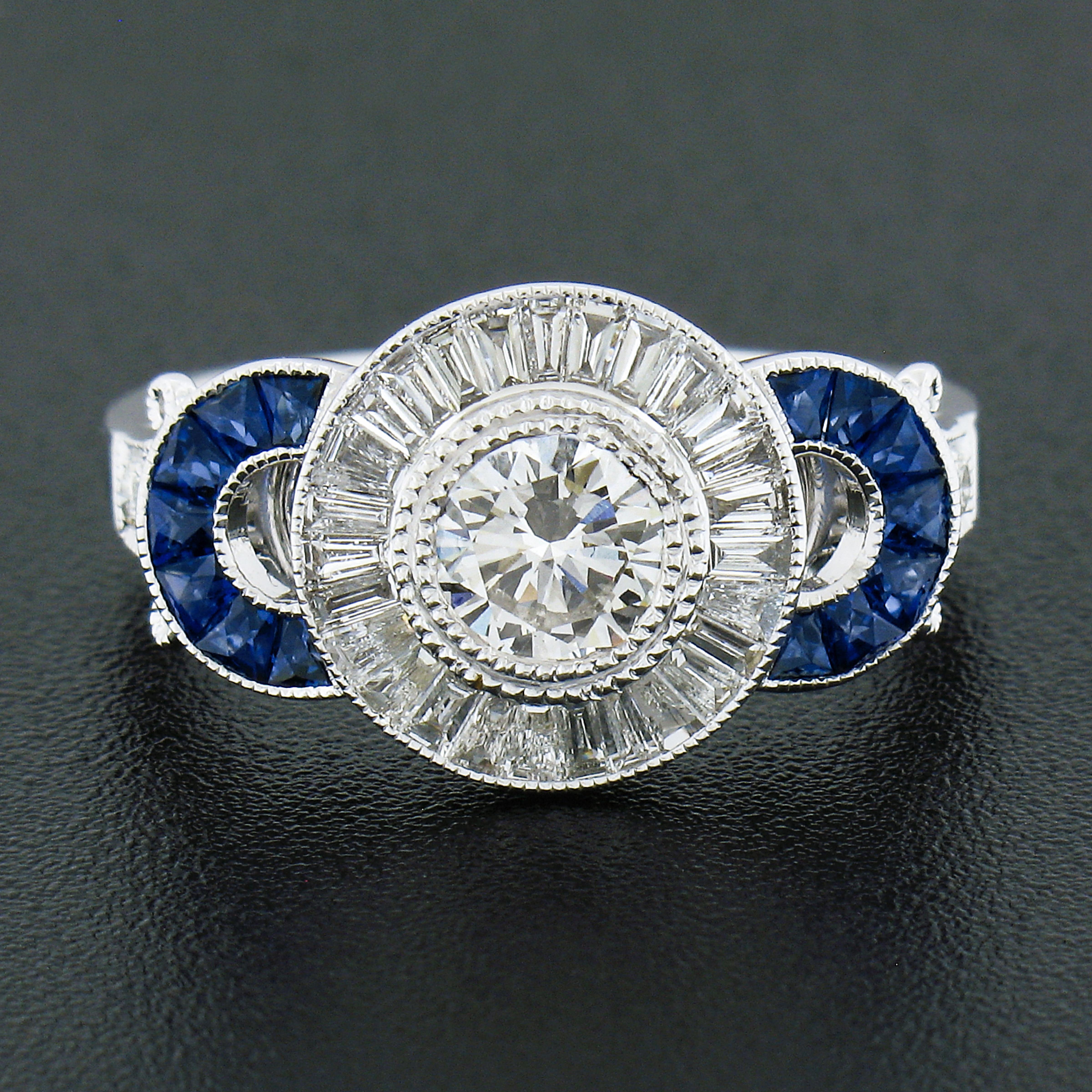 Here we have a brand new and absolutely breathtaking diamond and sapphire ring that was crafted from solid 18k white gold. This very well made ring features a stunning, GIA certified, round brilliant cut diamond neatly set at the center in a doubled