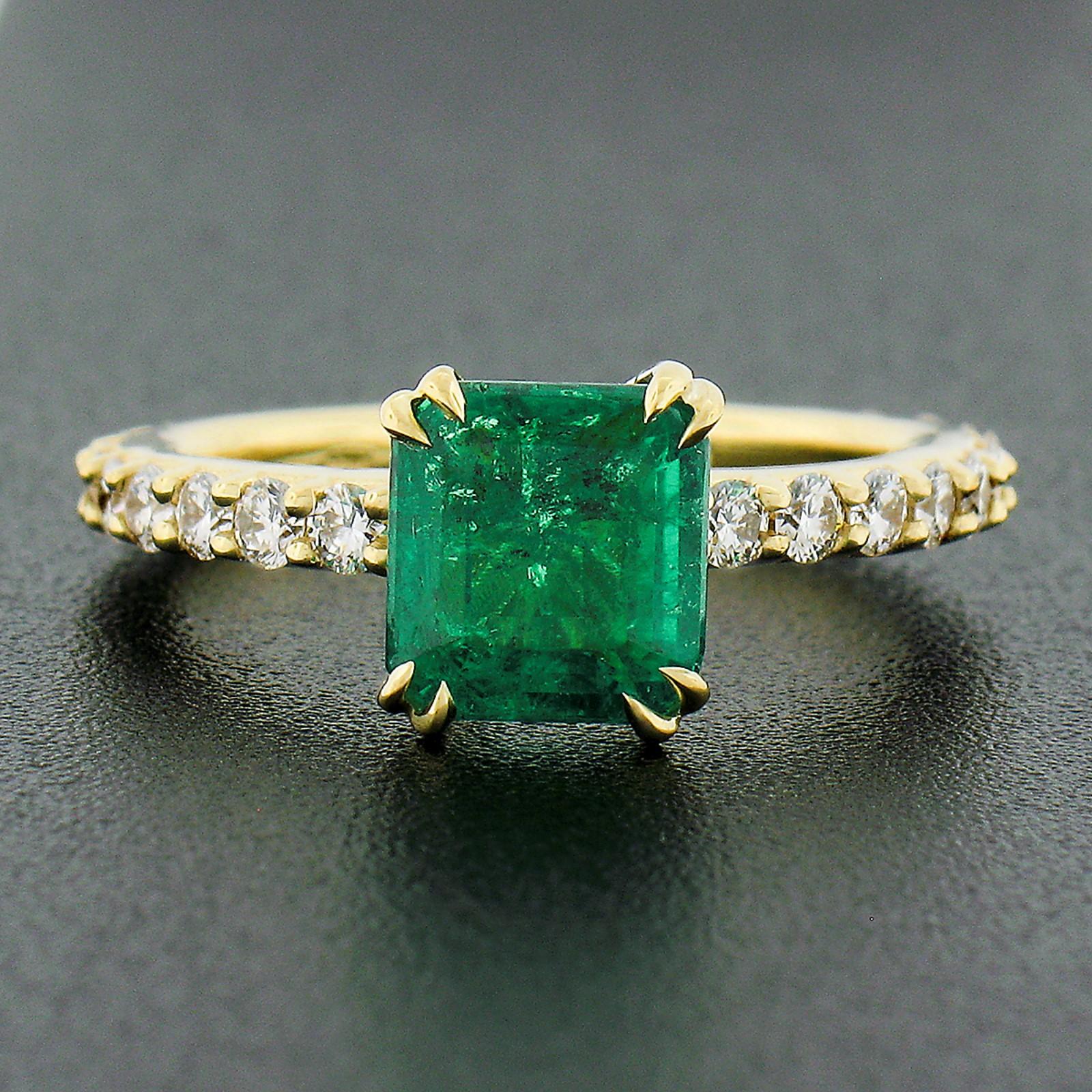 This stunning, SSEF certified, Colombian emerald and diamond engagement or cocktail ring is newly crafted in solid 18k yellow gold. The ring features a truly breathtaking, natural, octagonal step cut emerald stone that displays the finest and most