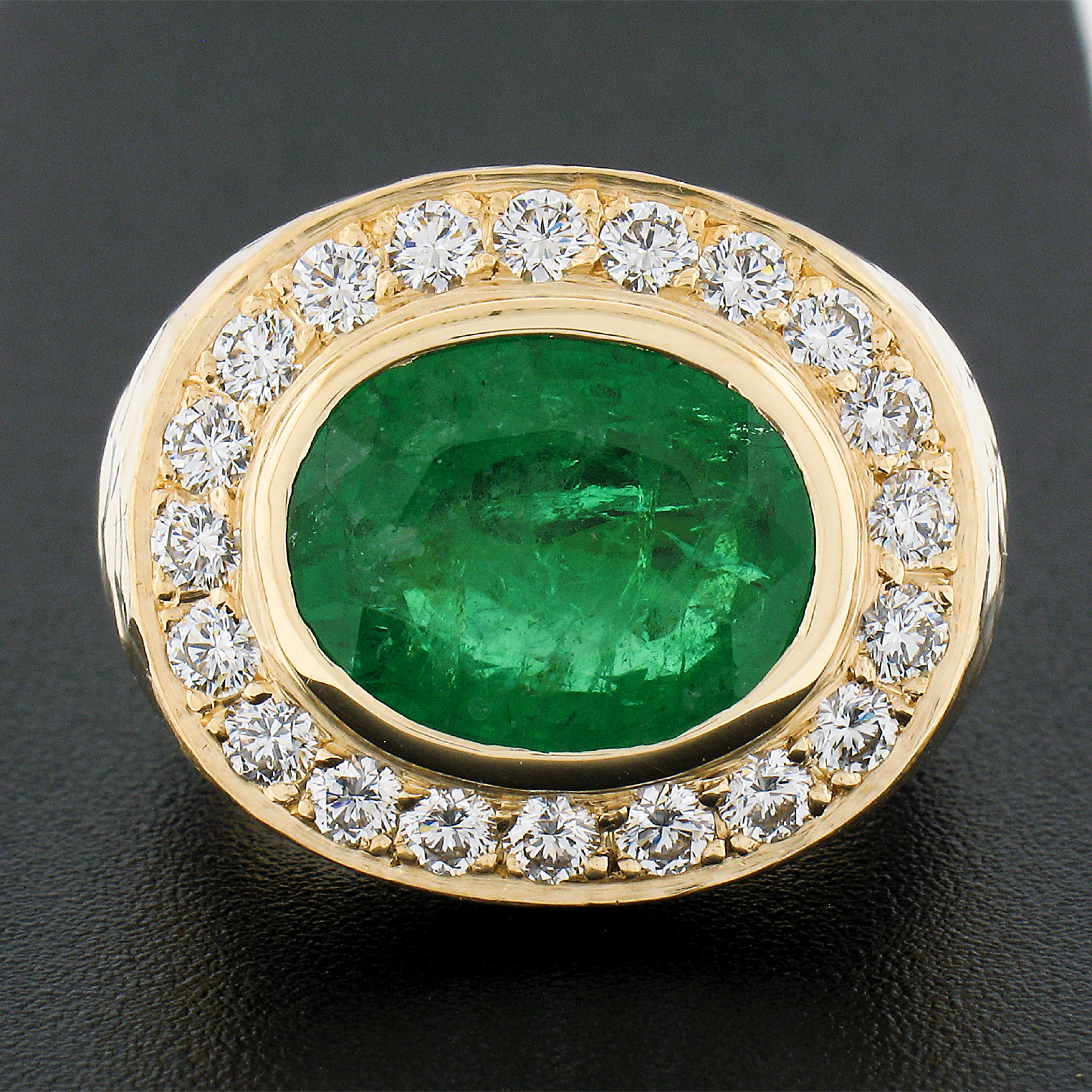 You are looking at a truly breathtaking, GIA certified, genuine emerald and diamond cocktail ring that is brand new and very well crafted in solid 18k greenish yellow gold. It features a large oval cut emerald solitaire neatly bezel set at the