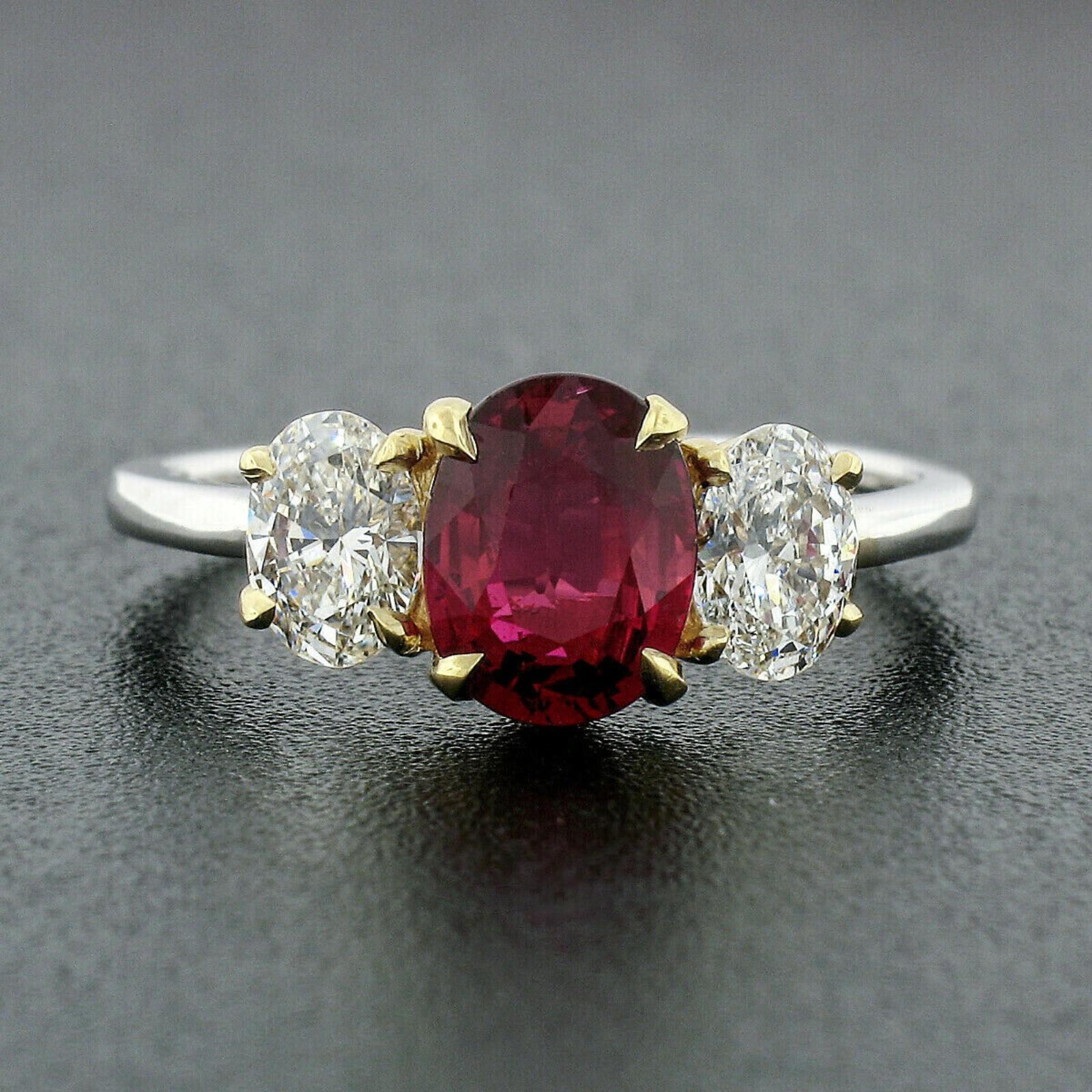 You are looking at a truly breathtaking ruby and diamond three stone engagement ring, hand crafted in solid 18k gold. The ring features a truly mesmerizing, GIA certified ruby solitaire hand set in the solid yellow gold basket and flanked on either
