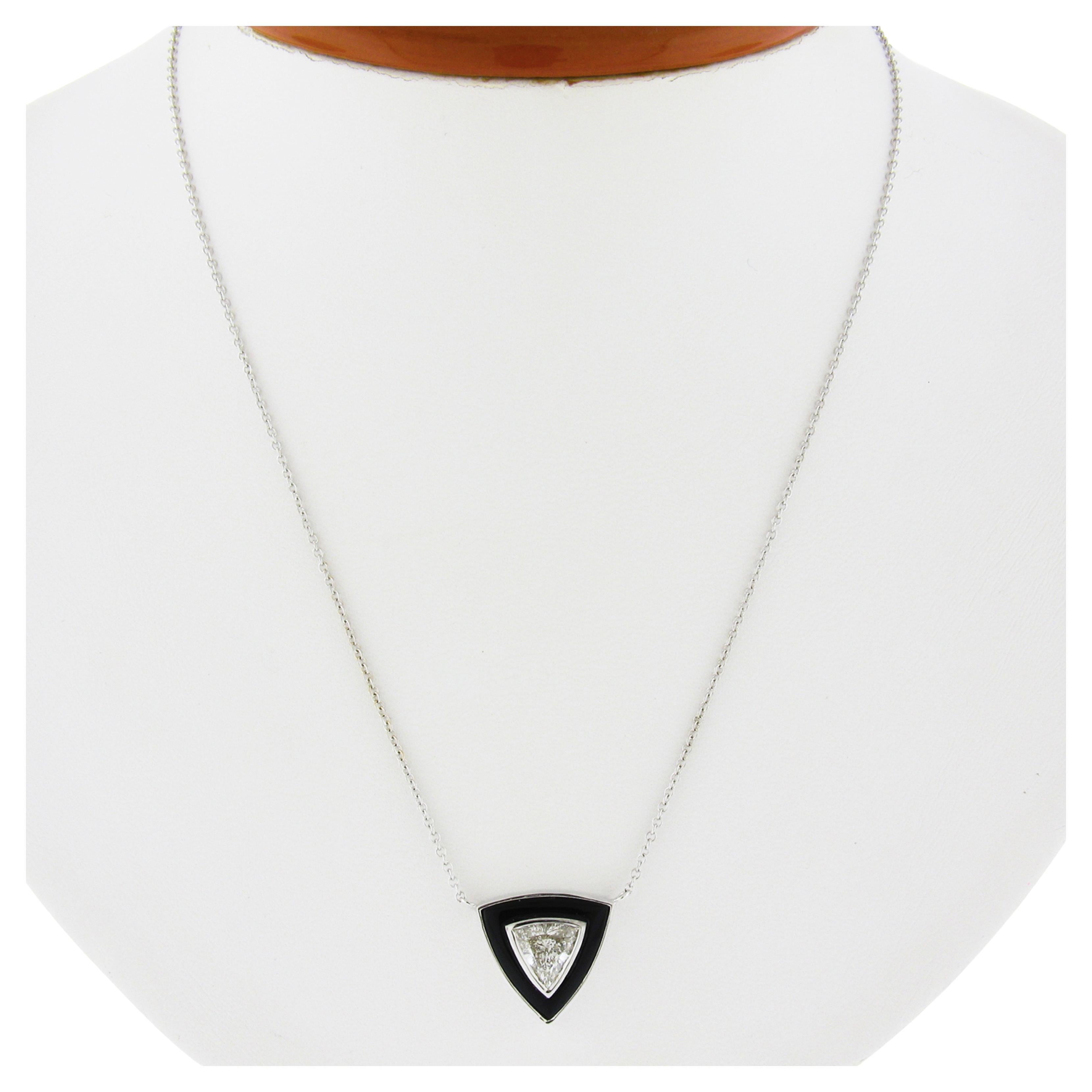 Here we have a gorgeous, brand new, and custom designed pendant necklace crafted in solid 18k white gold. The triangular shaped pendant features a fine, GIA certified, trillion cut diamond solitaire neatly bezel set at the center, and further