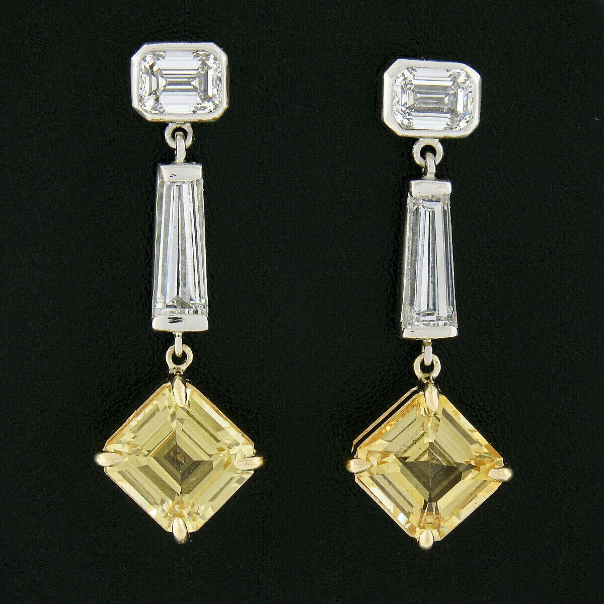 Here we have an absolutely magnificent and breathtaking pair of brand new, custom made earrings that are very well crafted in solid platinum and 18k yellow gold. They feature a truly elegant drop dangle style with a matching pair of stunning, GIA