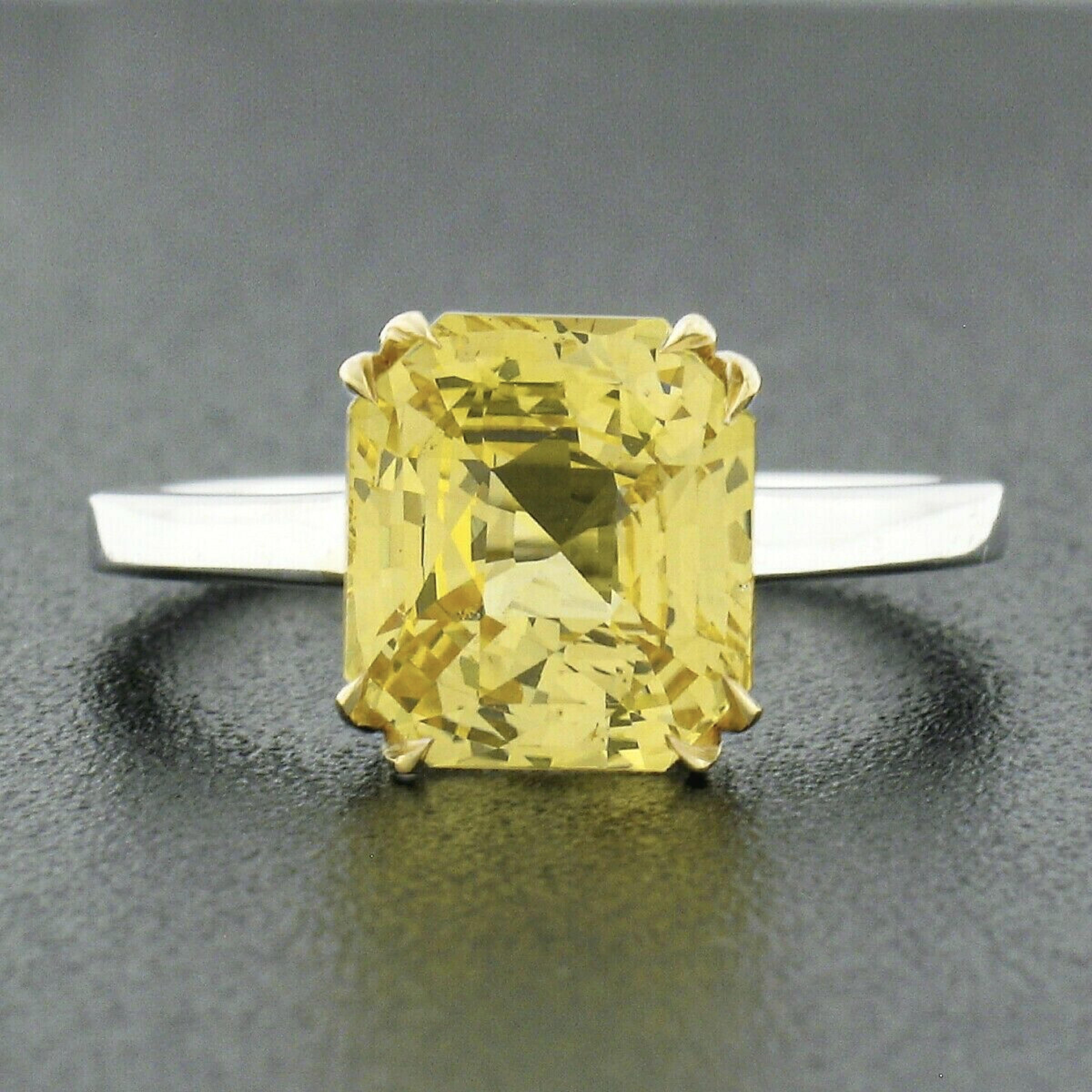 Here we have a truly magnificent yellow sapphire solitaire ring newly crafted from solid 18k yellow and white gold. The ring features a natural, GIA certified, brilliant cut yellow sapphire that weighs exactly 4.09 carats and is perfectly dual