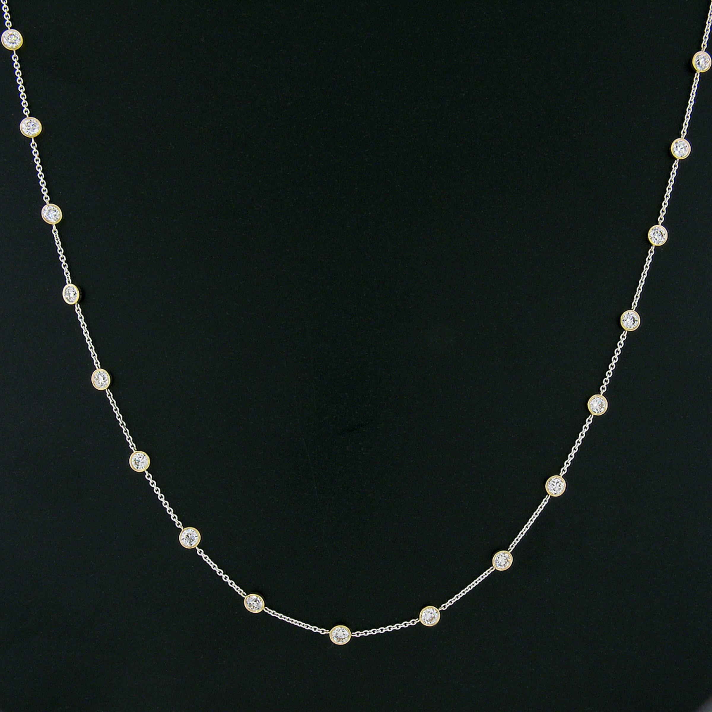 This gorgeous, custom made, diamond by the yard necklace is newly crafted from solid 18k white and yellow gold. It features a white gold cable link chain with 19, evenly spaced, yellow gold bezel stations that carry the stunning diamonds throughout