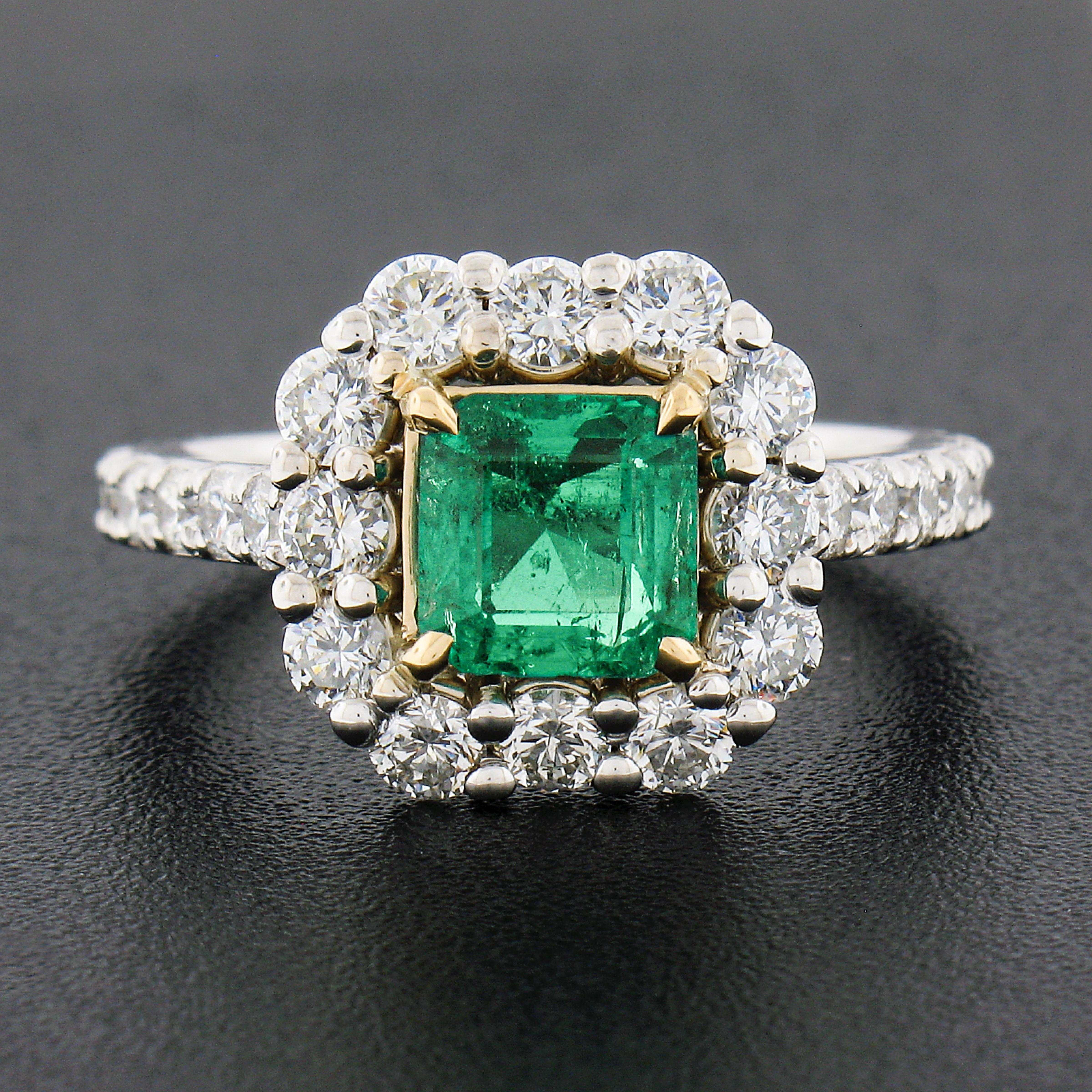 Here we have an absolutely gorgeous, brand new, emerald and diamond cocktail ring crafted in solid 18k white and yellow gold. The ring features a beautiful, GIA certified, natural emerald stone that displays an incredible vivid green color, prong