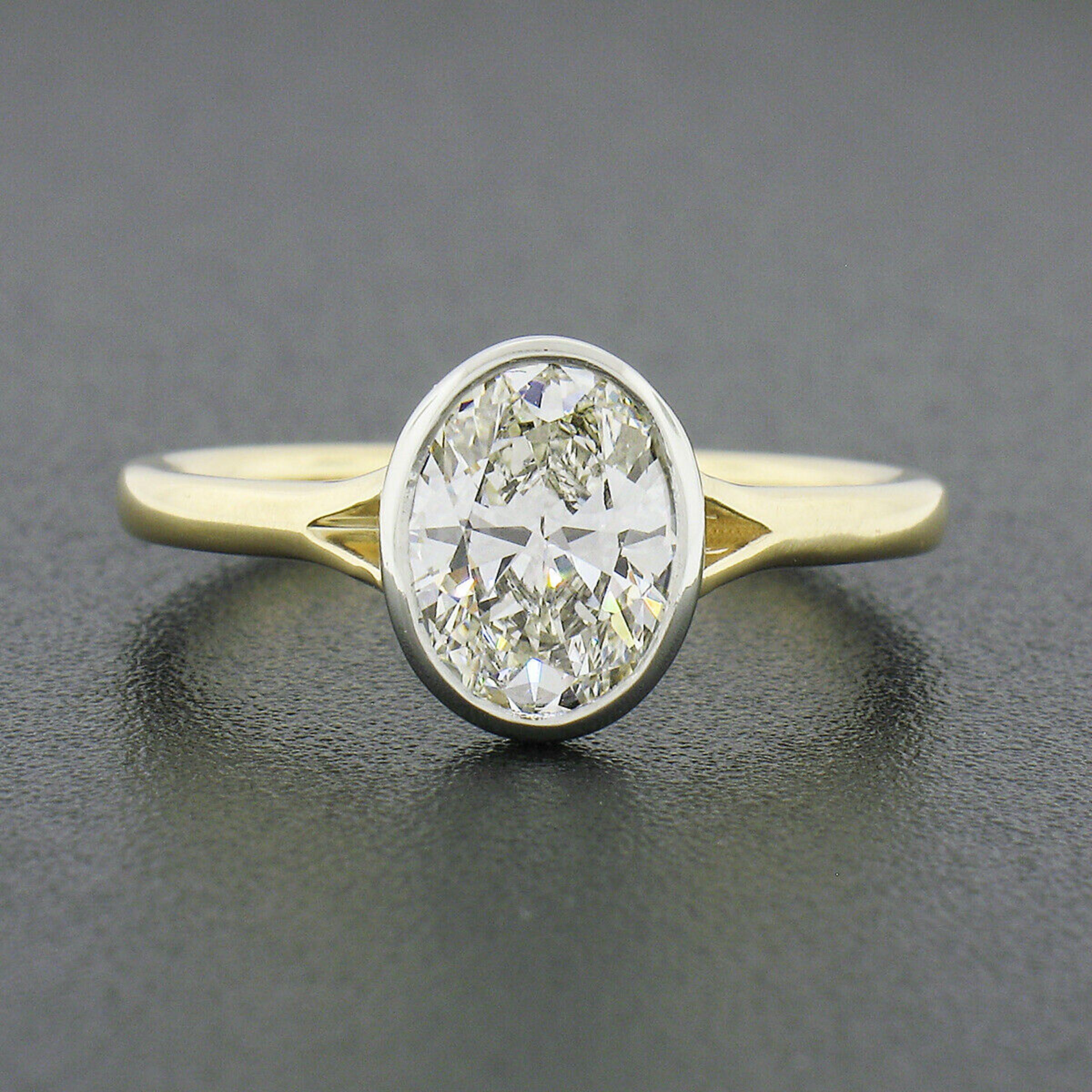 Here we have an absolutely gorgeous diamond solitaire engagement ring newly crafted from solid 18k yellow and white gold. The diamond is GIA certified and shows a large and attractive size, weighing exactly 1.20 carats in weight. The oval brilliant