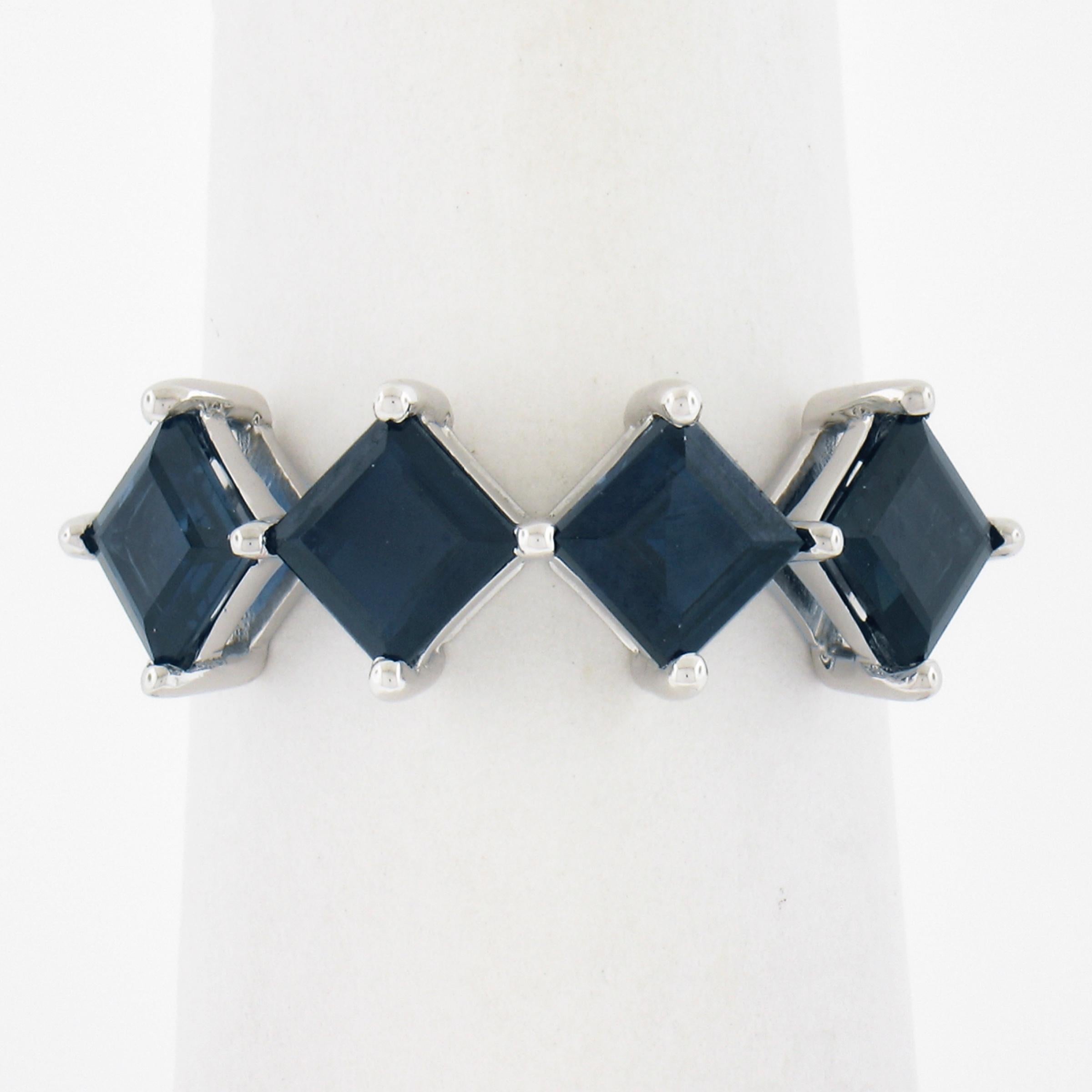 --Stone(s):--
(4) Natural Genuine Sapphires - Square Step Cut - Prong Set - Dark Blue Color 
Total Carat Weight:	2.30 (exact)

Material: Solid 18K White Gold
Weight: 3.80 Grams
Ring Size: 6.5 (Fitted on a finger. We can custom size this ring -