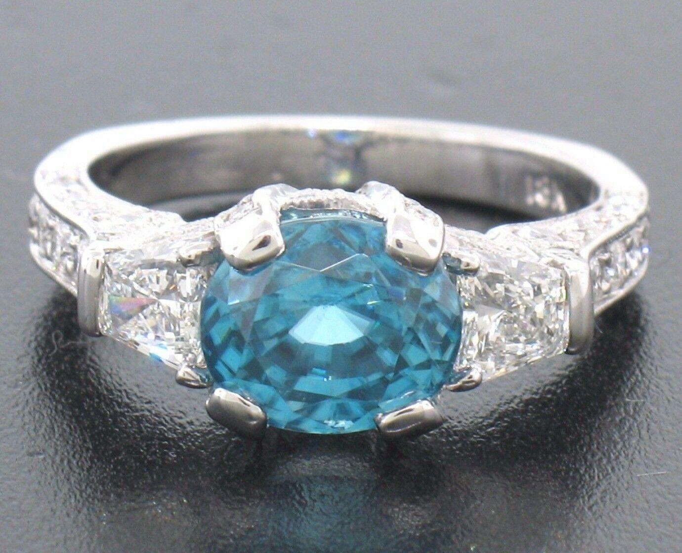 A natural blue zircon with this color at this size is very hard to find. When you add it to a mesmerizing 18k white gold mounting covered in top quality diamonds and accented by trapezoid cut stones, you have yourself a ring fit only for a very