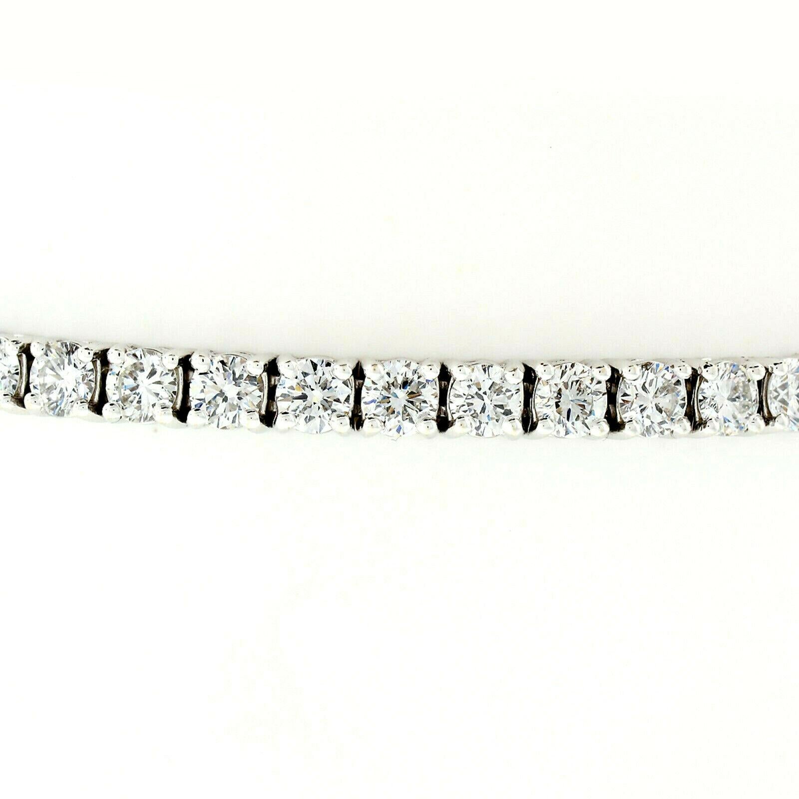 This stunning, classic diamond line tennis bracelet is newly crafted in solid 18k white gold and set with 45 very fine quality round brilliant cut diamonds throughout. Each diamond individually sits in a fine and sturdy 4-prong basket setting. The