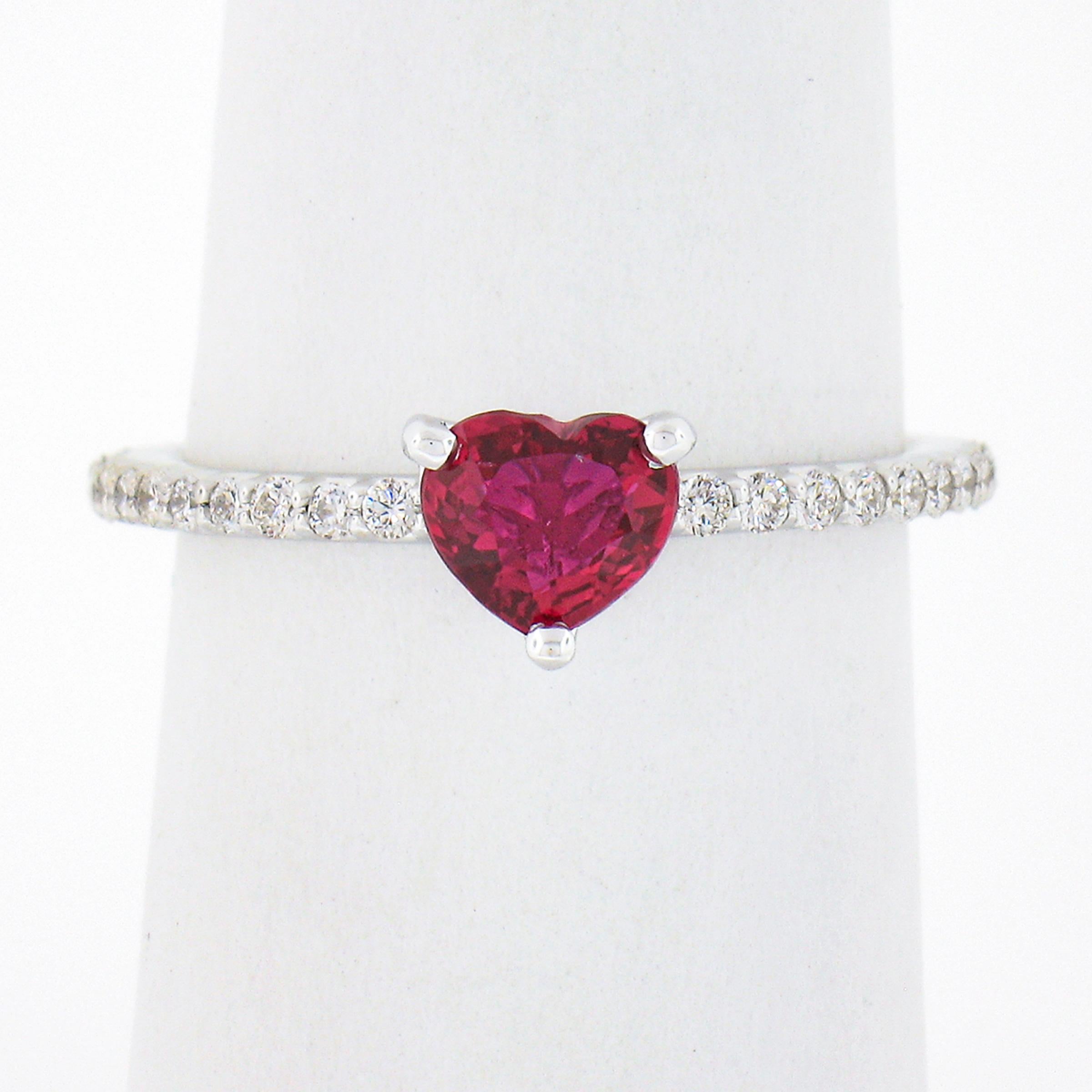 Here we have an absolutely lovely ring that is newly crafted from solid 18k white gold featuring a gorgeous heart shaped, GIA certified, natural ruby at its center. This very fine quality ruby has the most attractive and desirable vivid red color