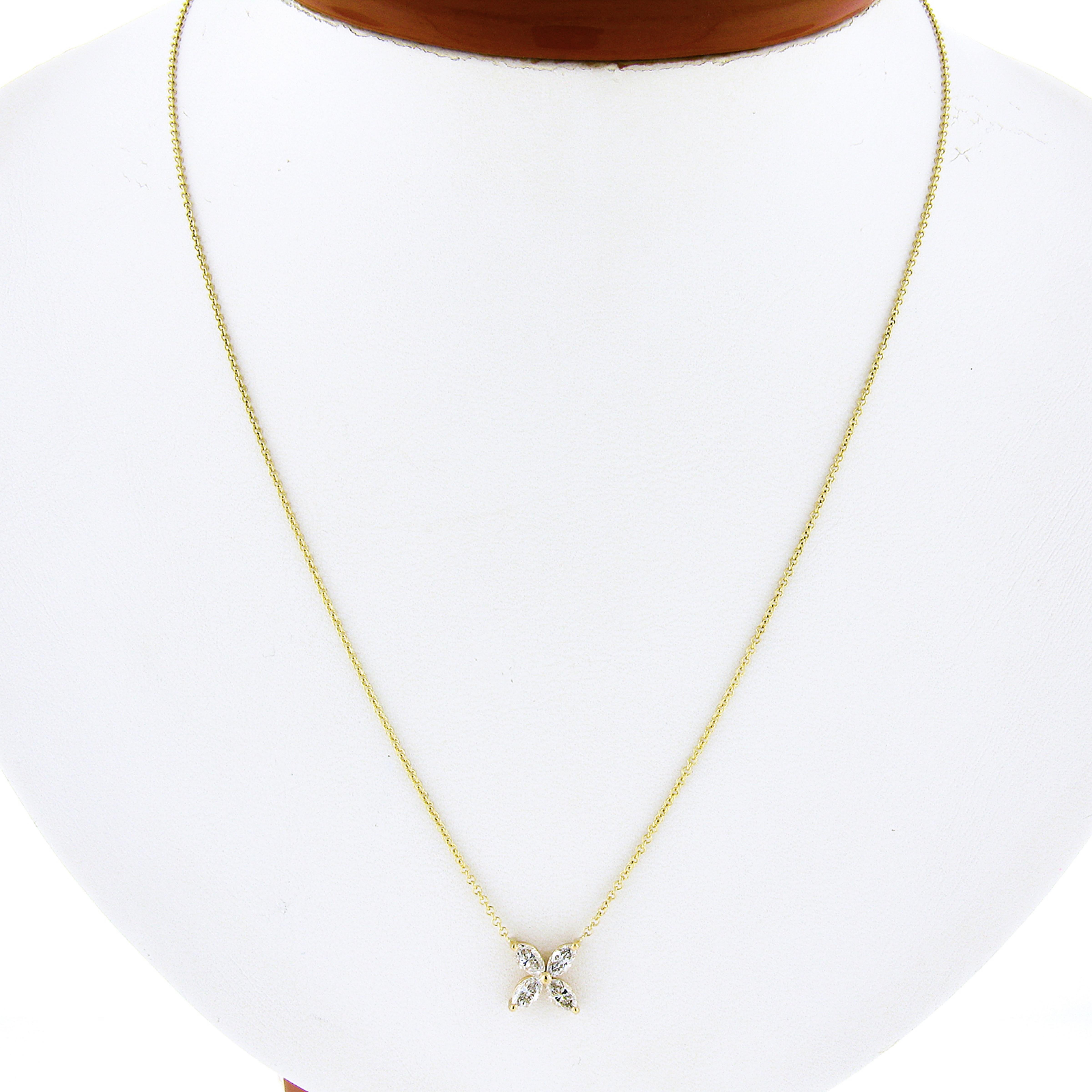 This gorgeous pendant necklace is newly crafted in solid 18k yellow gold, and features a lovely flower-shaped pendant that consists of 4 marquise cut diamonds.  The fiery diamonds are perfectly prong set on an open basket setting, and total 0.56