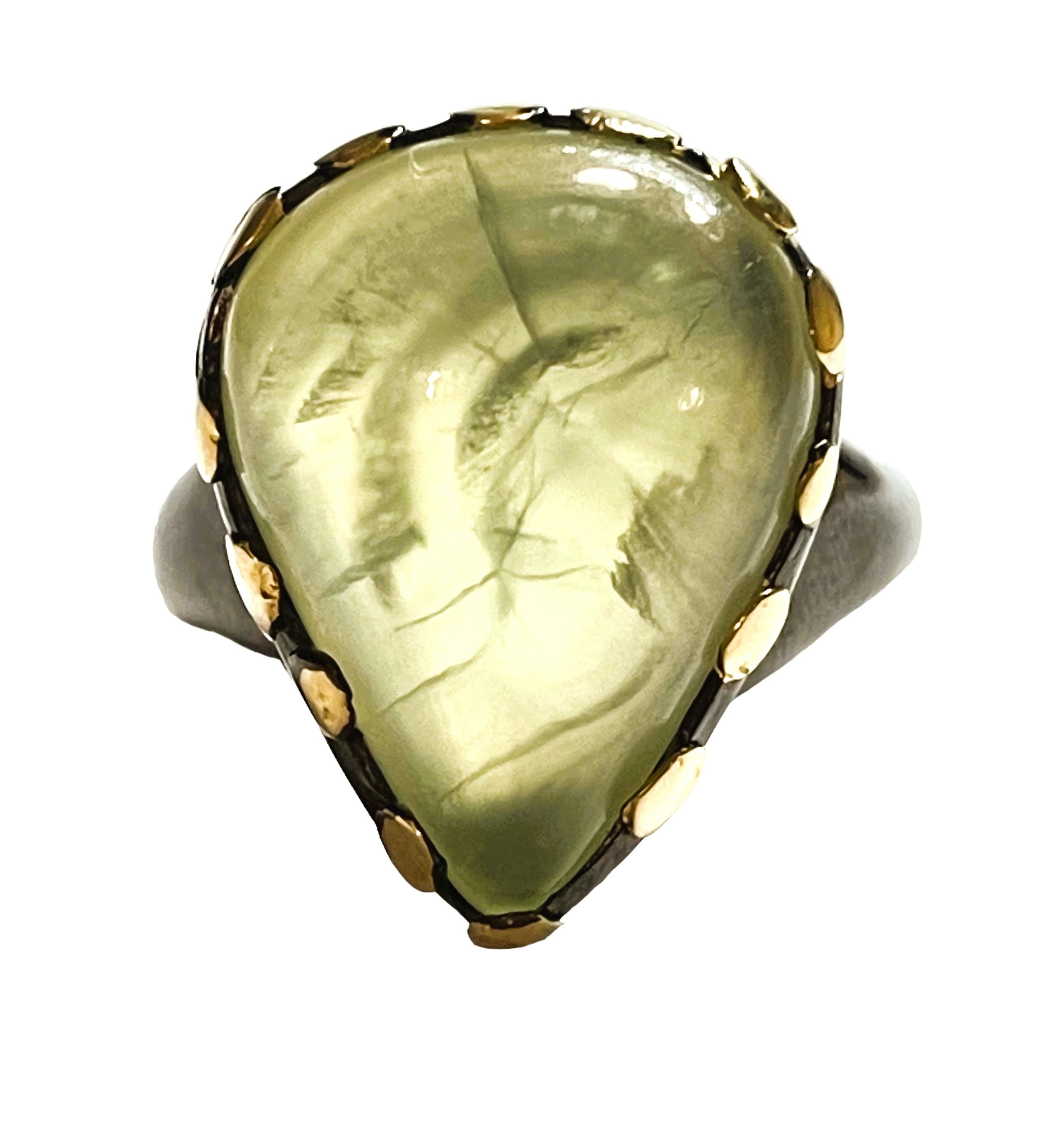 What a gorgeous ring!  It is a size 8.5.   It is an authentic natural stone.  So you can bid with confidence.   I just love this color and the beautiful setting it's in with the yellow gold accents on a Oxi-Black Sterling setting.  It is an pear cut