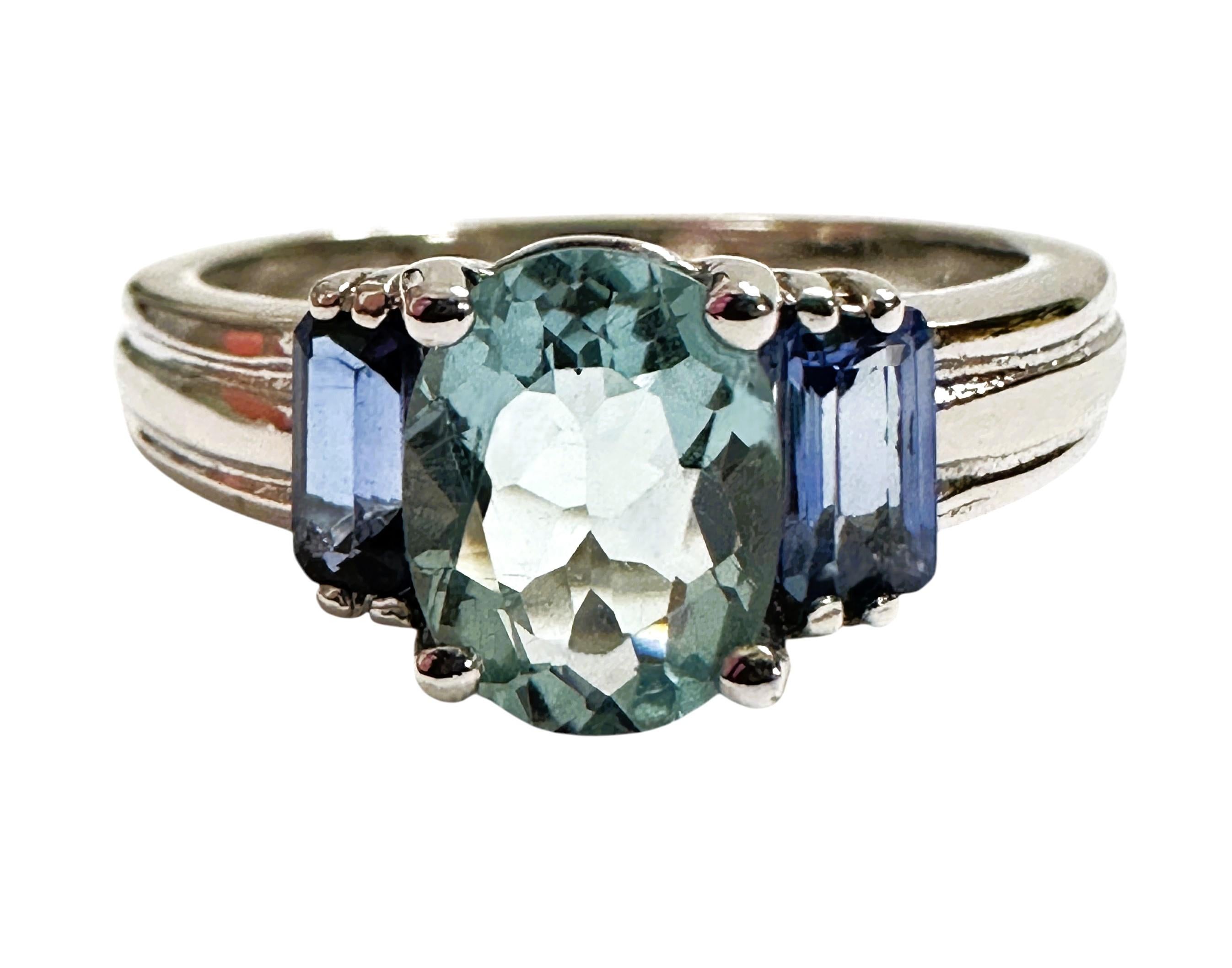 The stone is from Brazil and is just exquisite. The stone is an ice blue aquamarine and is 1.90 cts.  The stone is an oval cut stone and measures 8 x 6.5 mm and has beautiful baguette cut Blue Sapphires on each side of it.   It's a great color