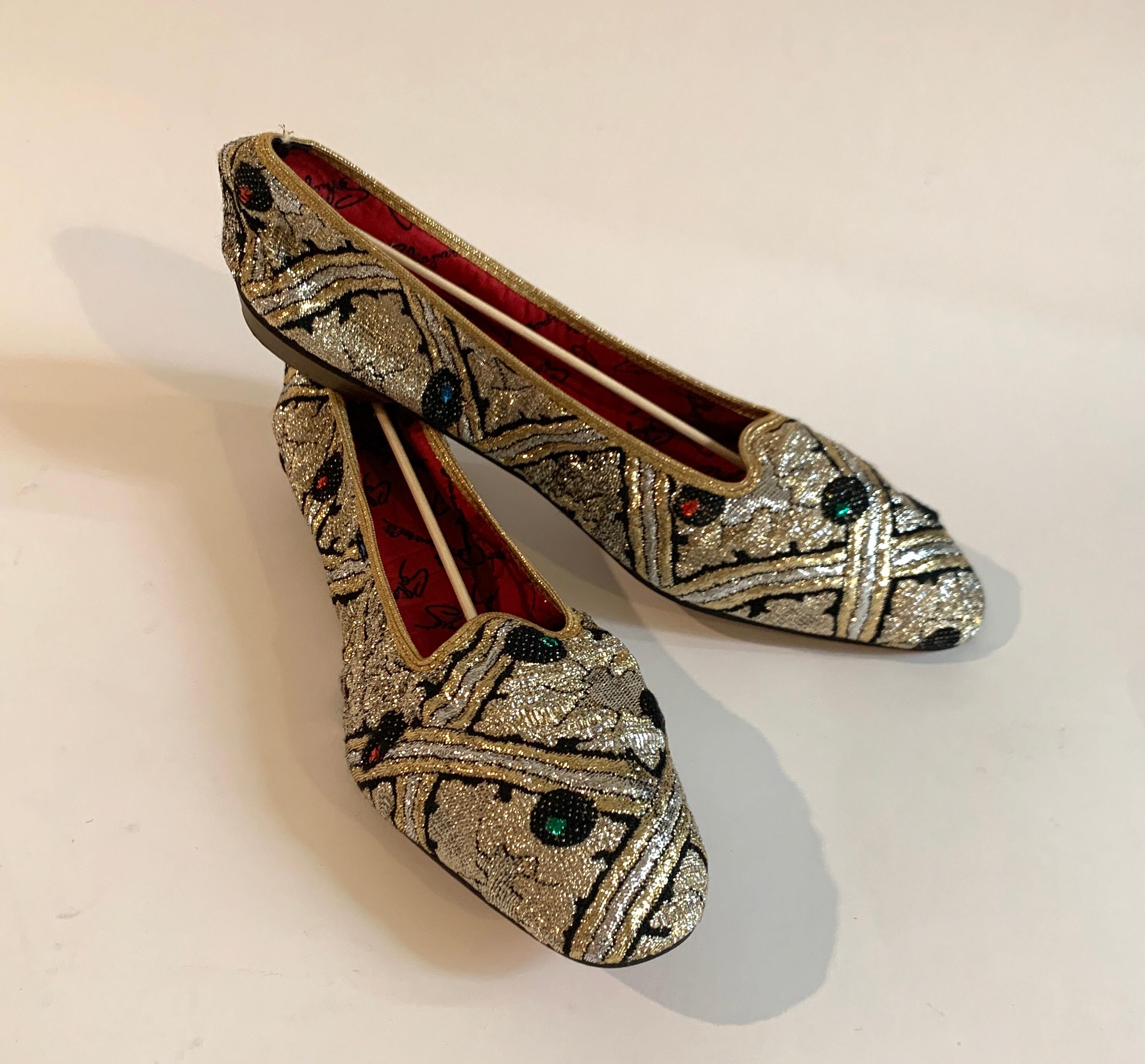 Elsa Schiaparelli 1960s deadstock foldable flats in silver and gold metallic brocade with green and red accents throughout. These utilitarian yet over the top flats are another amazing example of Schiaparelli being ahead of the times. Red
