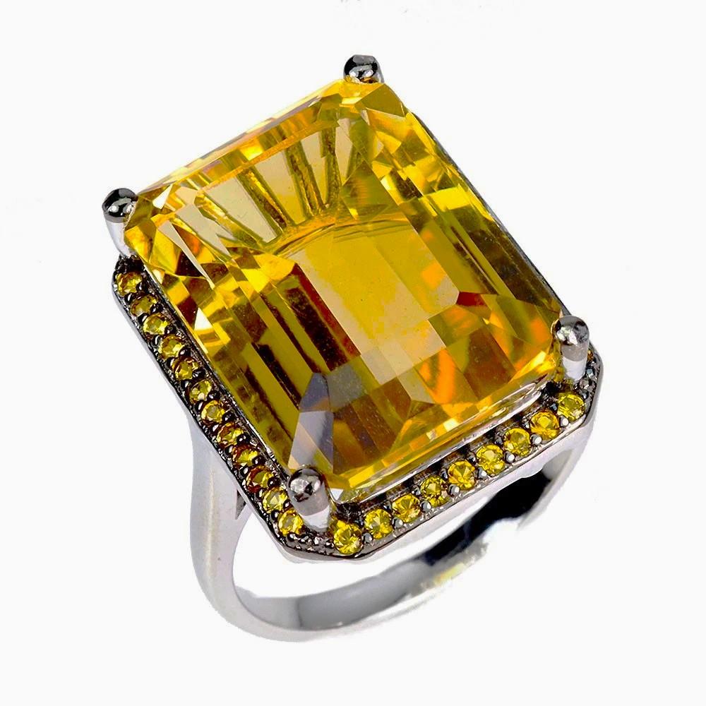 What a gorgeous ring!  This stone is from Brazil and just a beautiful shade of dark yellow and orange.  The ring is a size 7.  It is a radiant cut stone and 18 x 13 mm.  It is surrounded by diamond cut yellow sapphire stones.  Those stones are set