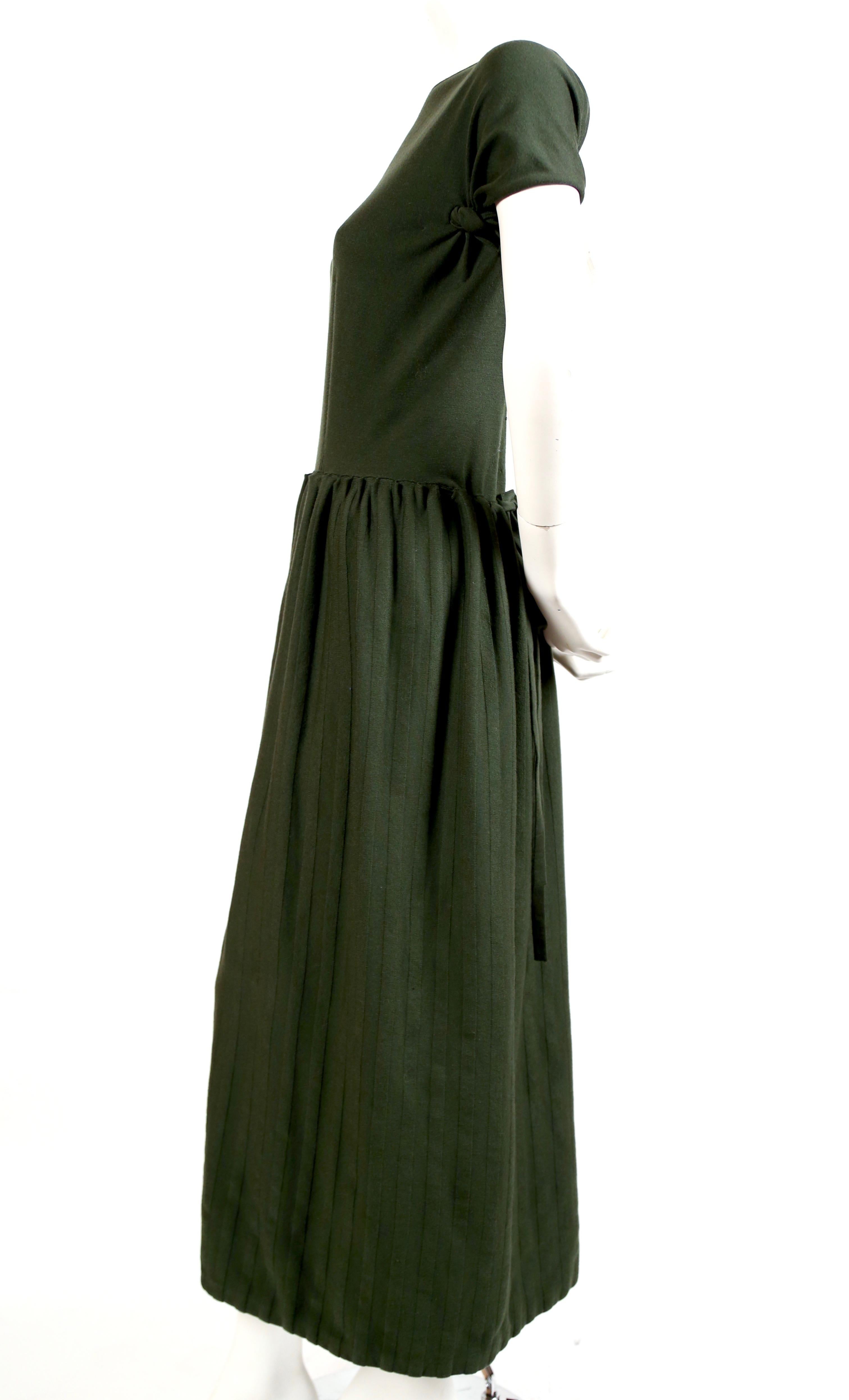 Forest green, knit dress with long striped skirt and open back from Azzedine Alaia dating to the 1990's. Labeled a French size S however there is some flexibility with the sizing due to stretchy knit. Approximately 52