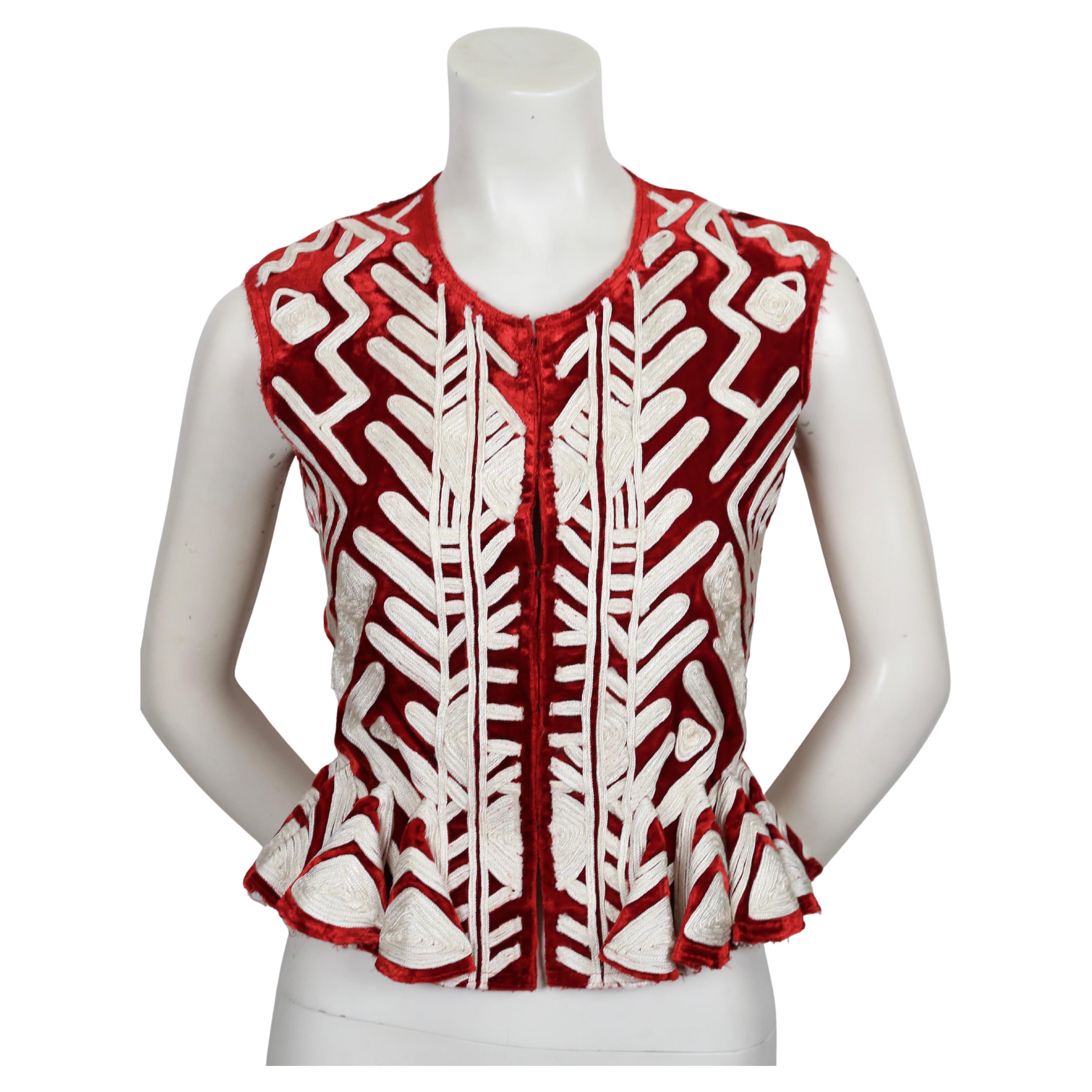 Stunning and very rare, crimson velvet peplum sleeveless jacket with intricate soutaché cord embroidery designed by Tom Ford for Yves Saint Laurent exactly as seen on the runway for Spring 2002 and featured in the Saint Laurent fall ad