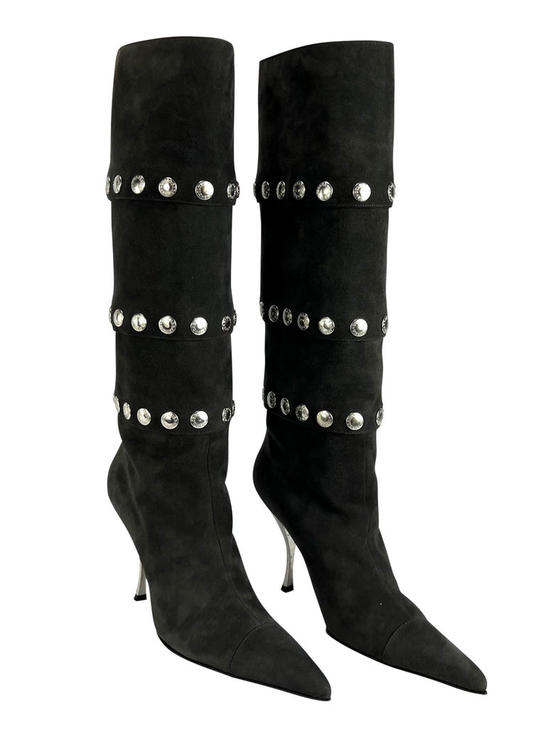 TheRealList presents: a fabulous pair of pointed dark grey suede Dolce and Gabbana boots. From the Fall/Winter 2003, these versatile boots are covered in silver-tone snaps which were heavily used on the season's runway. The snaps on these heeled