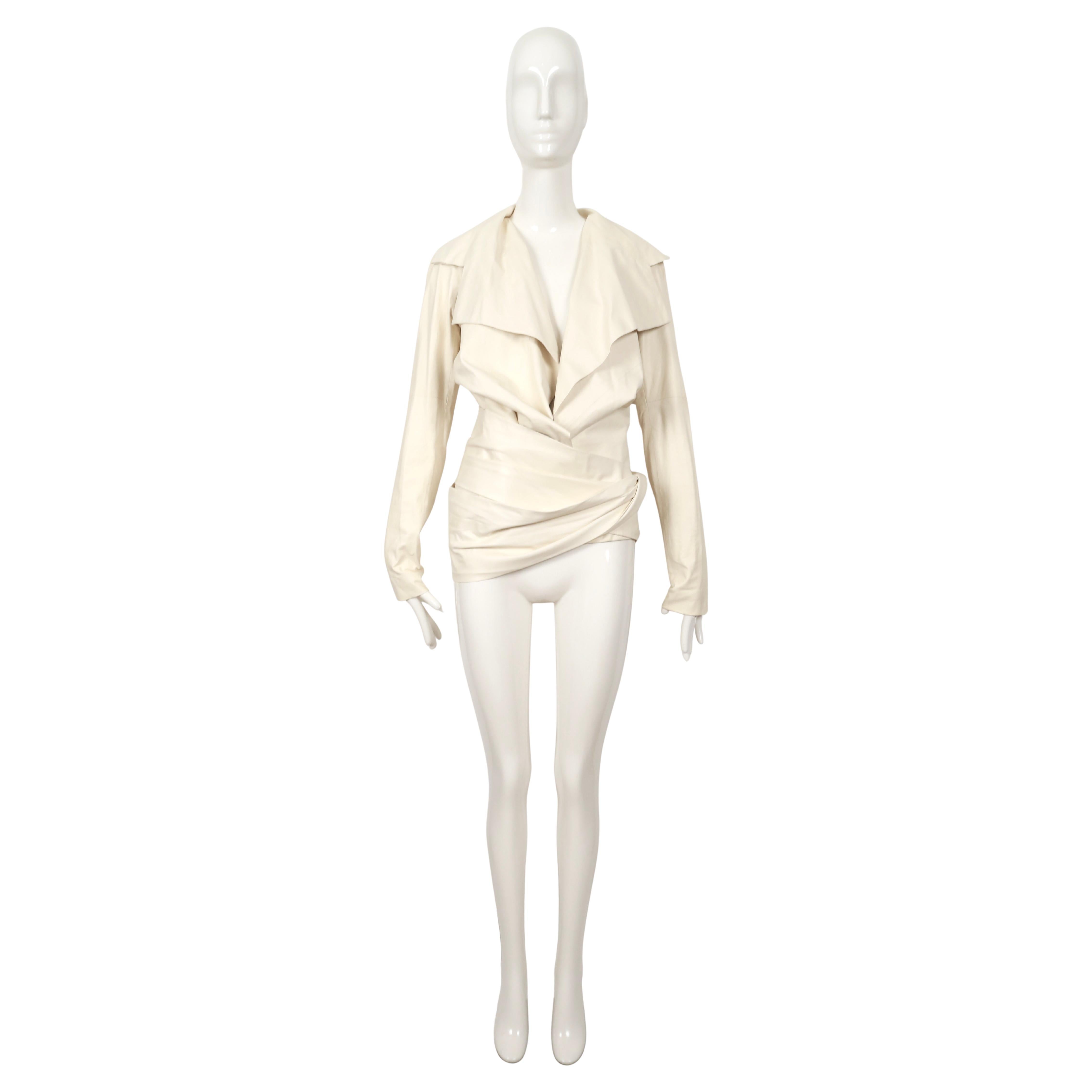 Off-white lambskin leather jacket with unique wrap closure designed by Tom Ford for Yves Saint Laurent spring 2004 exactly as seen on the runway. Belt can be worn at waist or hips. Jacket is labeled a French size 38 although this also fits a FR 36.
