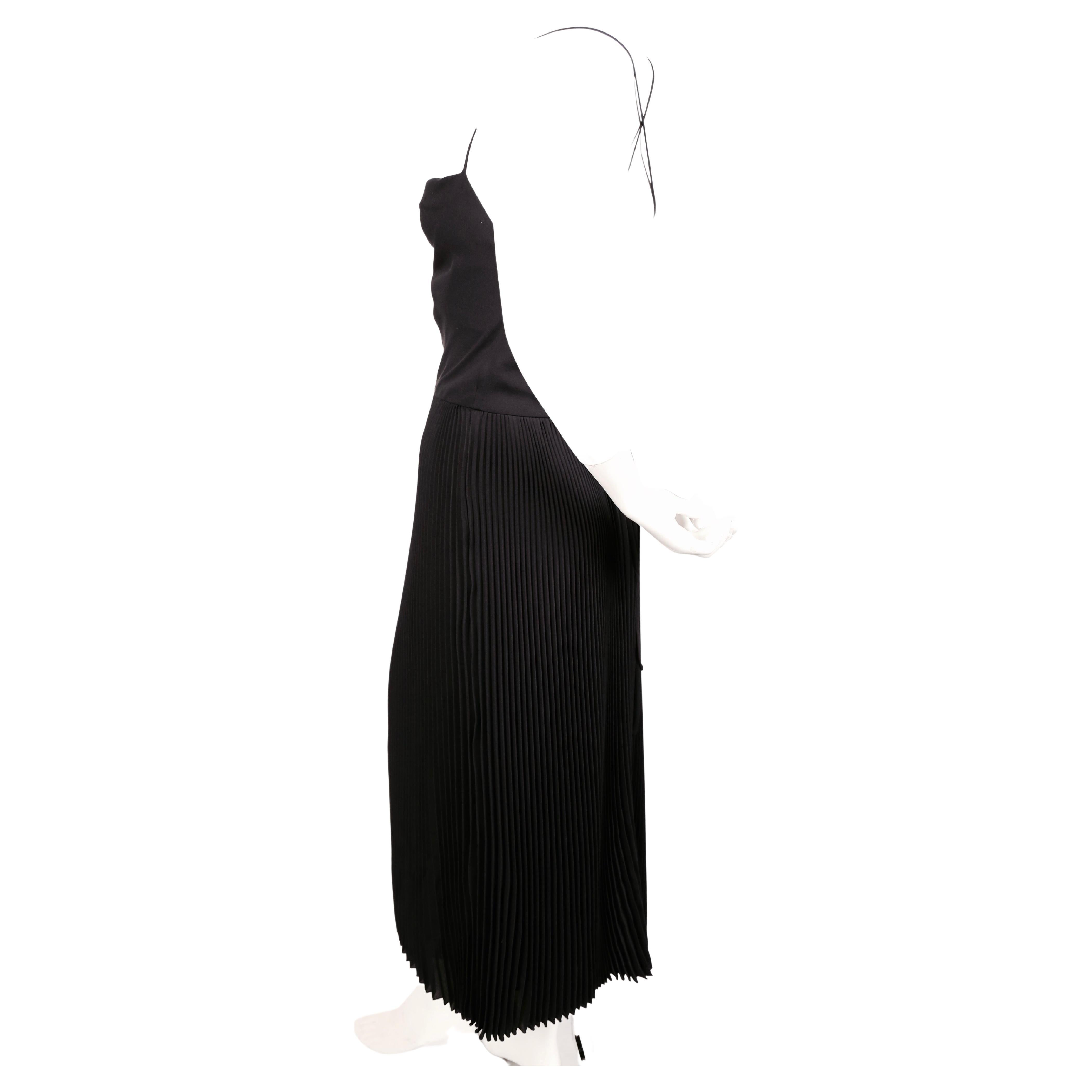 Black silk dress with plissé folds and elegant draping from Valentino exactly as seen on the runway for fall of 2016. Italian size 40. Approximate measurements: bust fits 32-35