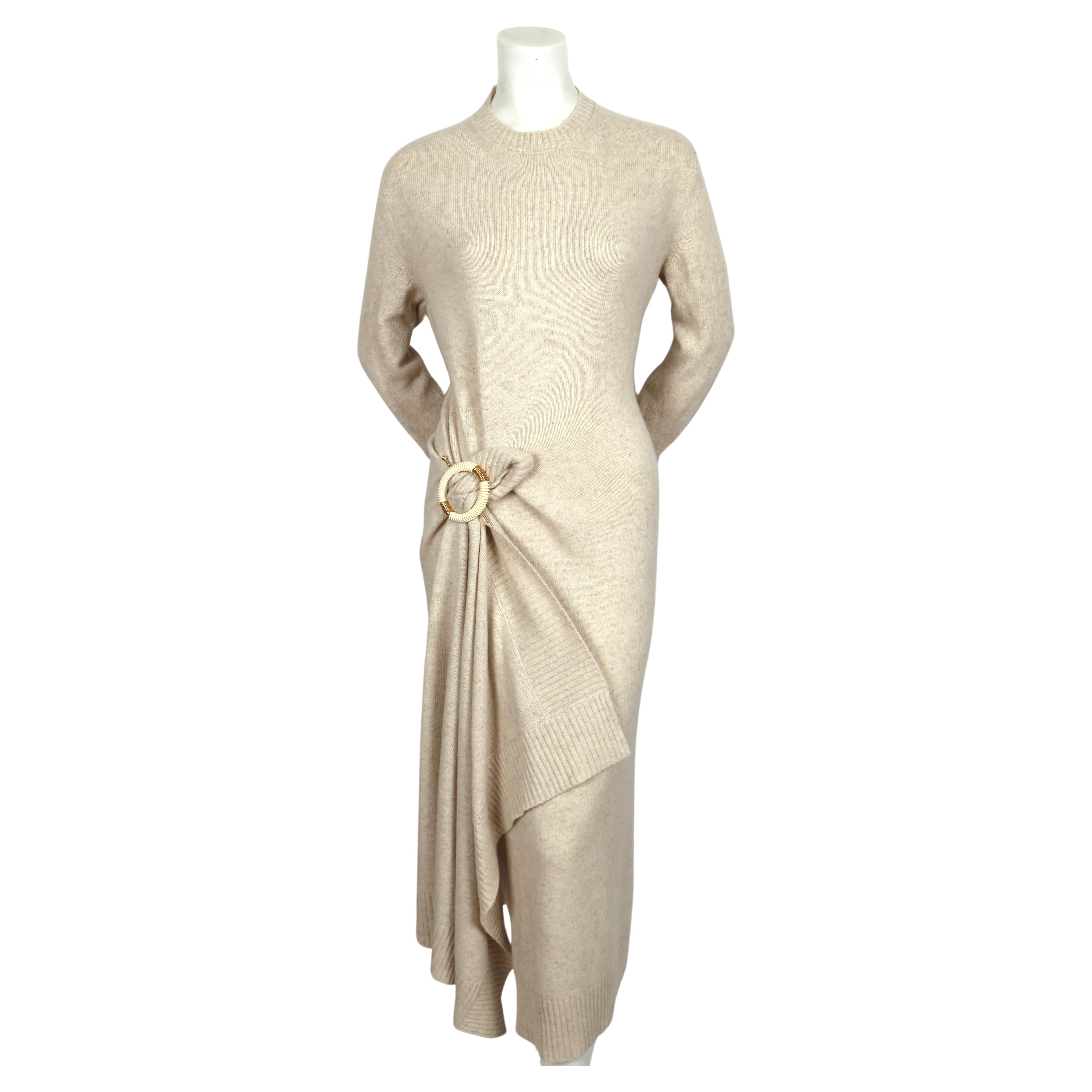 Fuzzy, beige, draped sweater dress with decorative brooch designed by Phoebe Philo for Celine dating to fall of 2018. Highly sought after piece from Phobe Philo's time at Celine. Dress is labeled a Size XS but also fits a S due to oversized cut. 