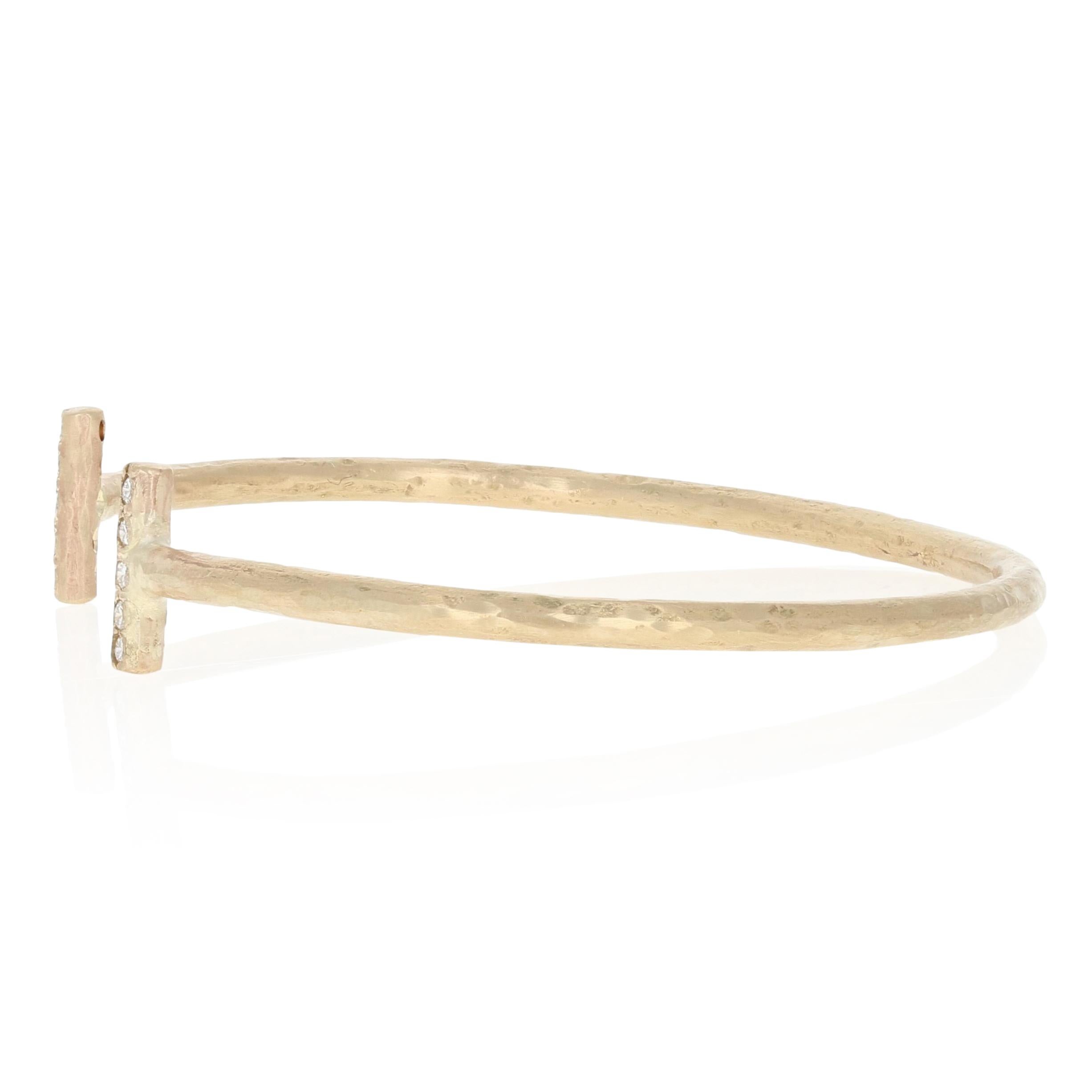 Celebrate the special woman in your life with this custom-made bracelet! Appropriately titled “Joy” and featuring a sleek oval silhouette, this NEW hammered cuff is beautifully crafted in 14k yellow gold and sparkles with ten white diamonds.  