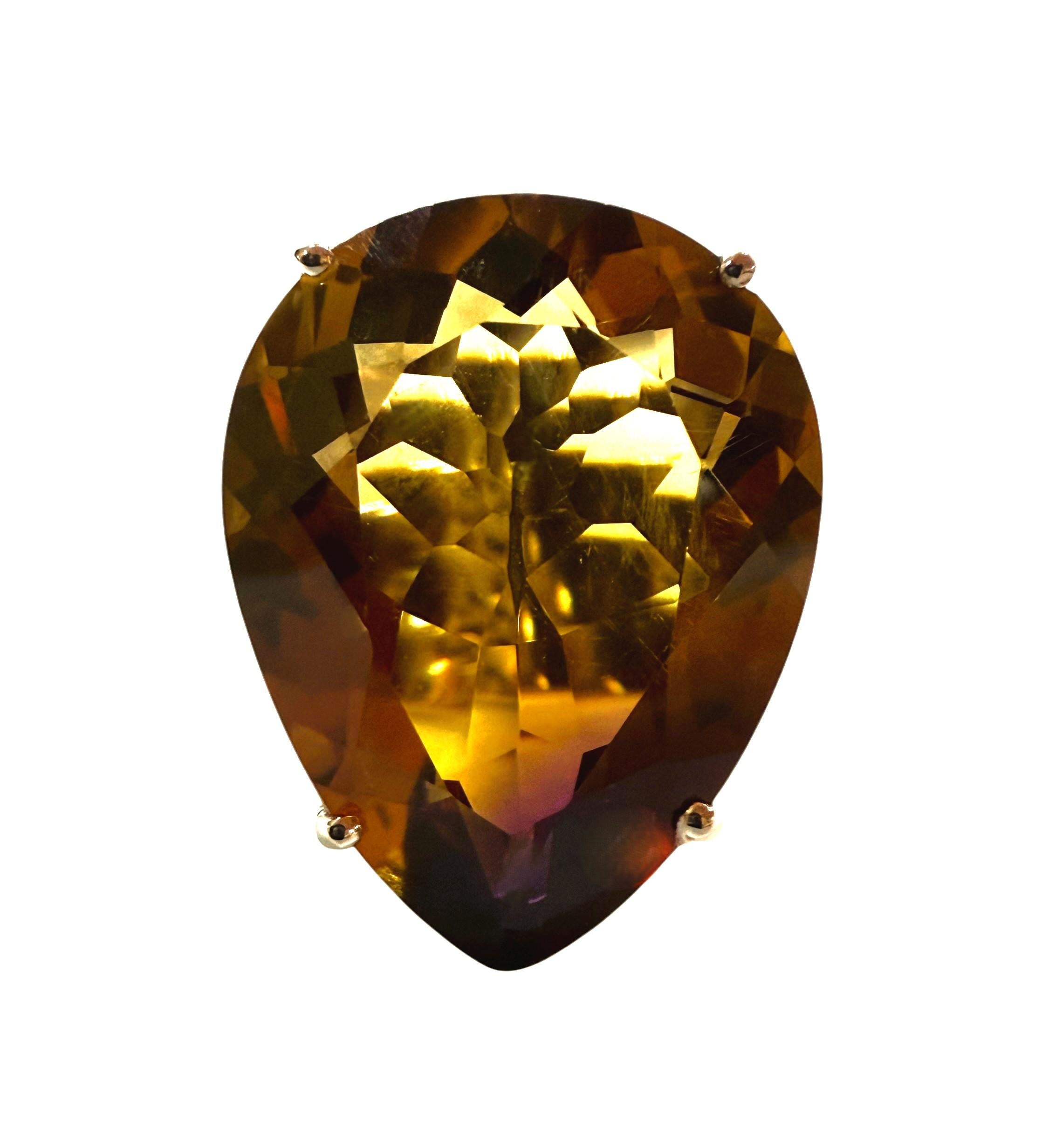 This ring is just so beautiful!  The stone is from Brazil and is just beautifully cut.  It is a very high quality stone and has shades of brown, yellow and purple.   It is a pear shaped stone and is 51 Carats.   The main stone is 23 x 18.3 mm and is