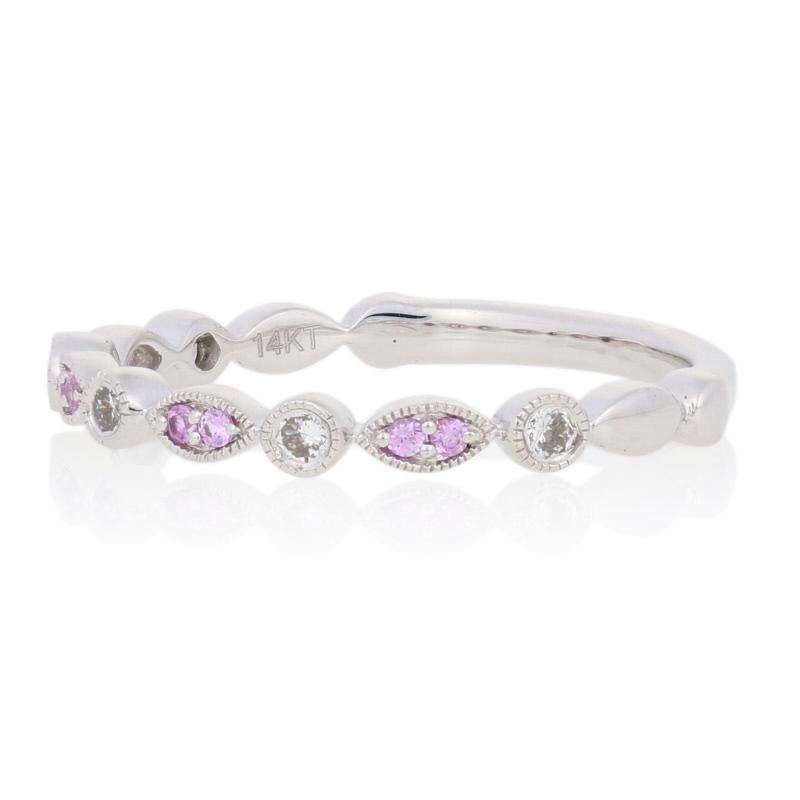 Add a sweet splash of color to your wardrobe with this beautiful NEW ring! Created in a stackable design, this 14k white gold band is illuminated by sparkling pink sapphires and diamonds outlined with milgrain borders.  

This ring is a size 6 1/2,