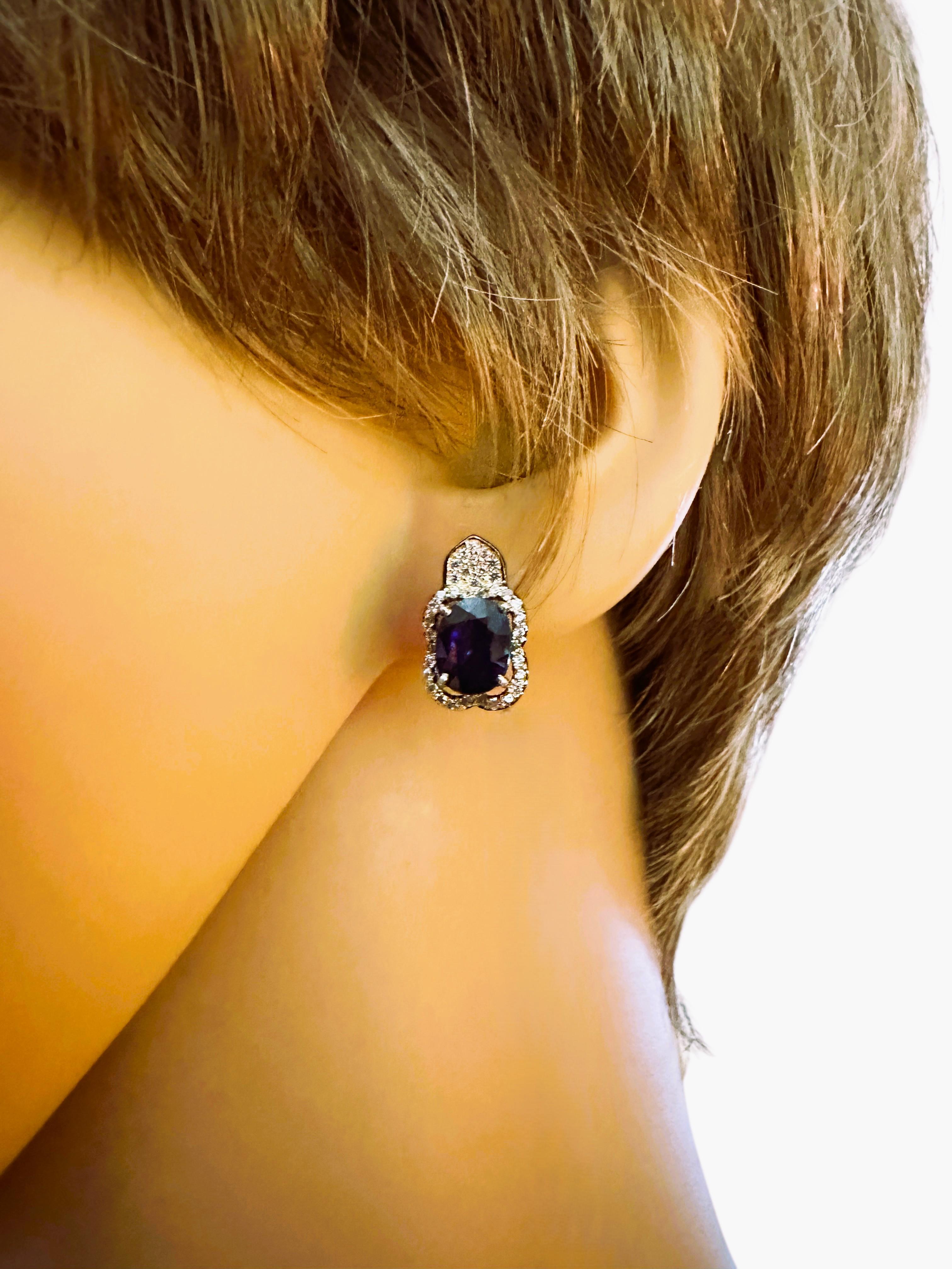 These are very beautiful and rich looking earrings. The stones are from Africa.  They are beautiful oval cut stones and are 1.30 carats each totaling 2.6 carats. It is a very high quality stone. They measure 8.5 x 6 mm and are surrounded by diamond