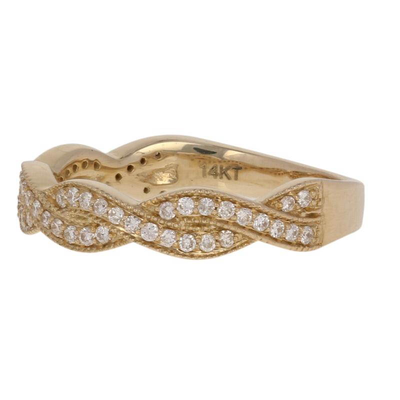 Sweetly symbolic and elegantly refined, this beautiful ring is destined to be cherished for a lifetime. This NEW 14k yellow gold band showcases an intertwined “ribbon” design adorned with white diamonds and ornate milgrain work.  

This ring is a