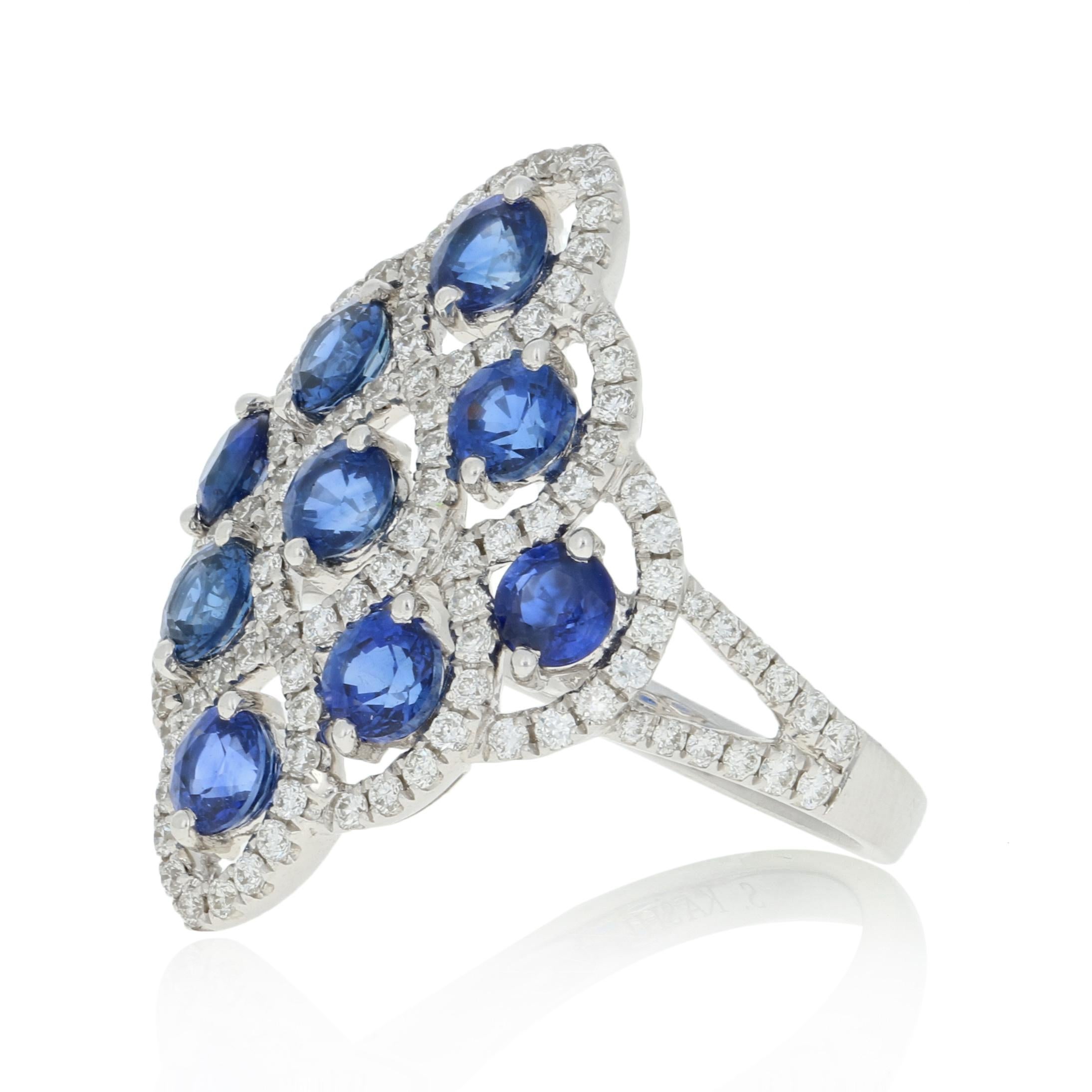 Graceful elegance defined! Artistically created in 14k white gold, this spectacular NEW halo-inspired ring features silky blue sapphires outlined by icy white diamonds.  

This ring is a size 6. Please contact us for a quote on re-sizing this ring.