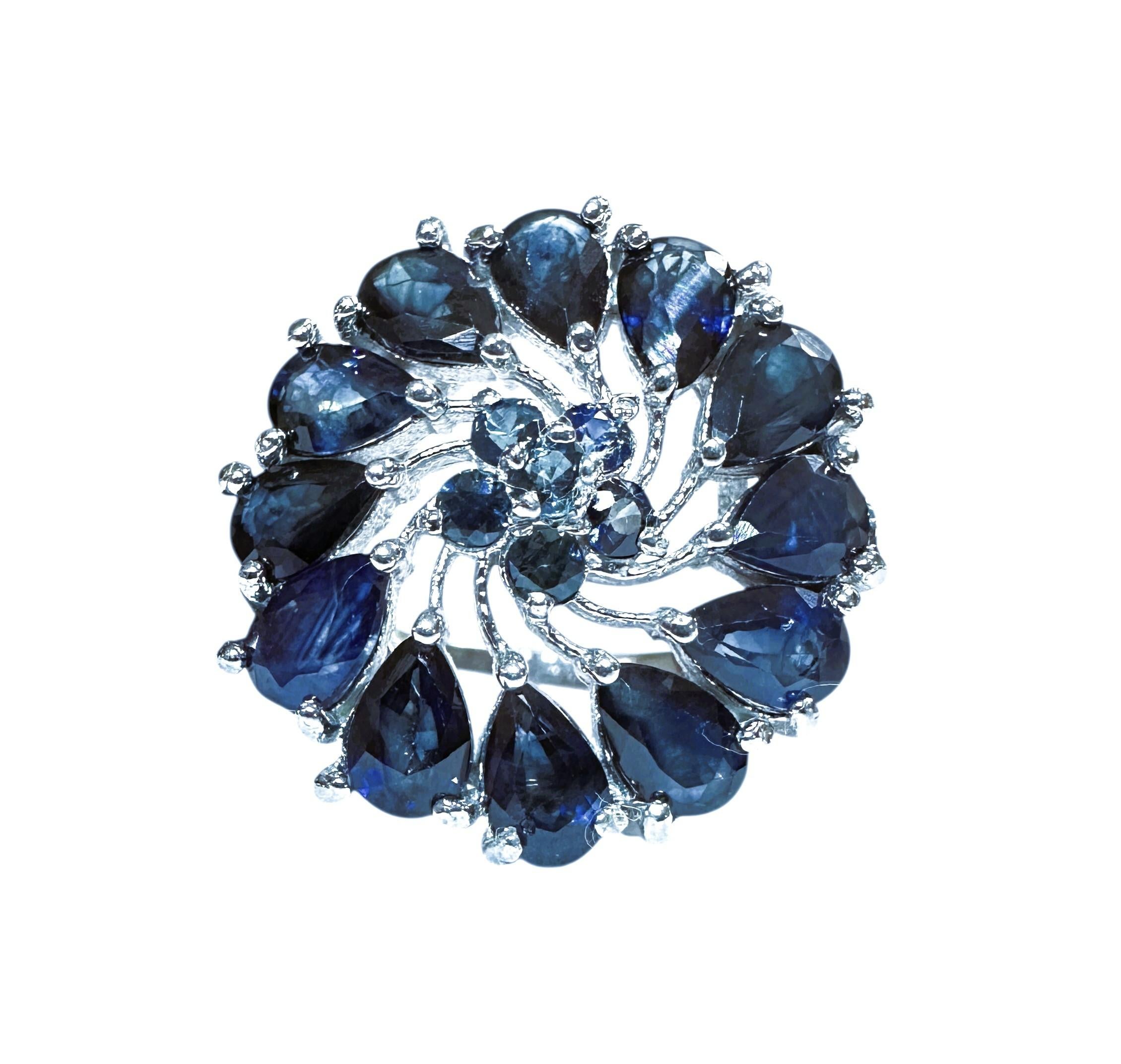 This is just a beautiful ring.  It is a size 7.  The ring has 12 pear cut Sapphire stones measuring approximately 5 x 3 mm.  They total 3.05 carats.  There are 6 diamond cut Blue Sapphires in the middle of the ring.  They are all set in a 925