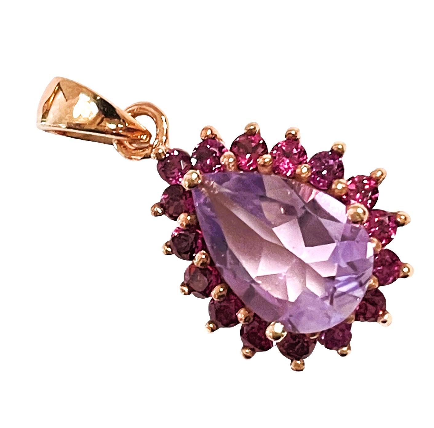 This pendant is just so beautiful!   It is a pear cut stone and is 3.2 Ct   The main stone is 11 x 9 mm and is surrounded by diamond cut Rhodolite Garnet stones. The pendant itself is 1 inch long and .5 inches wide.  The weight in Grams is 3.20.  I