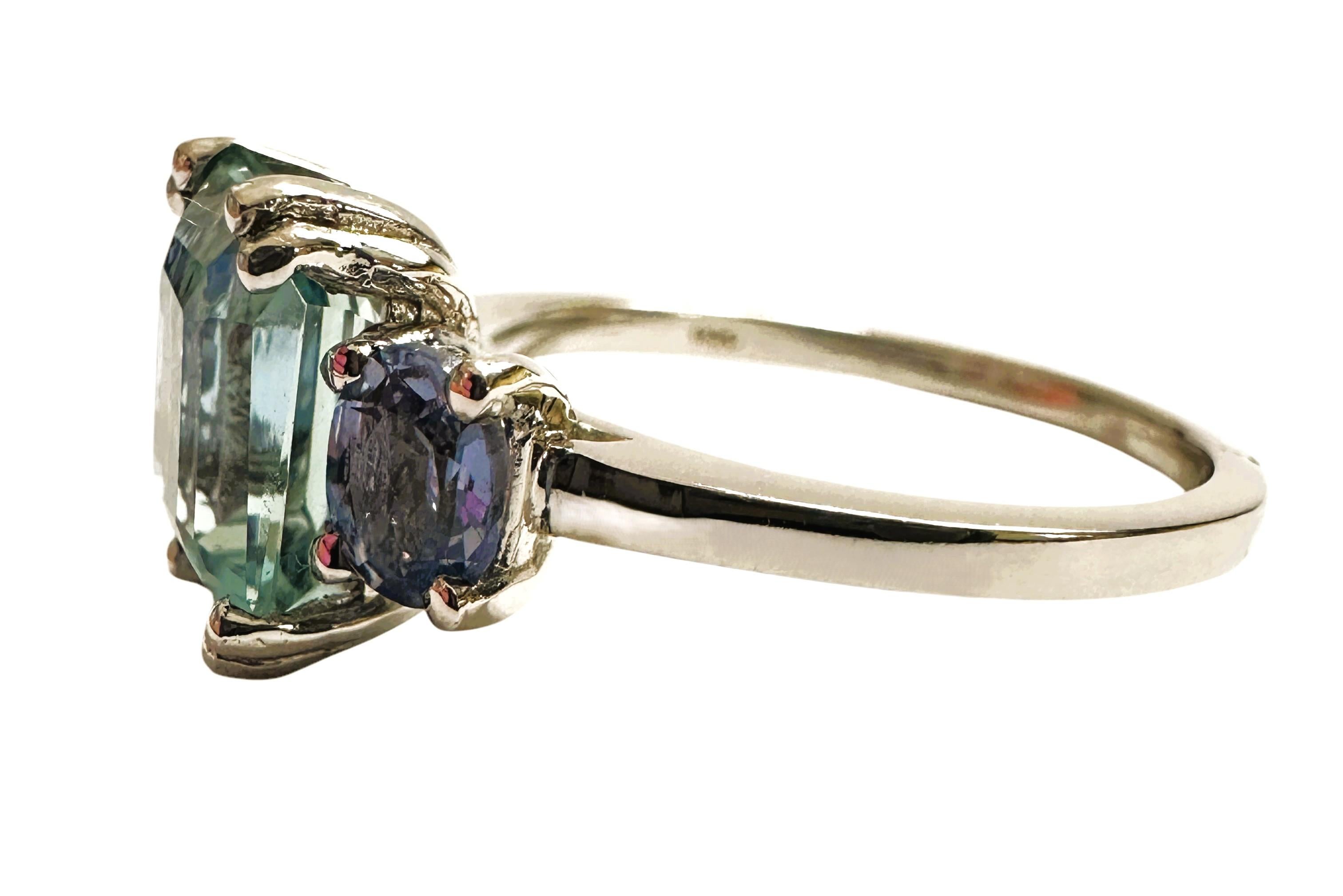 The stone is from Brazil and is just exquisite. The stone is a sea blue aquamarine and is 3.20 cts.  The stone is a baguette cut stone and measures 9 x 7.2 mm and has beautiful oval cut Blue Sapphires on each side of it.   It's a great color