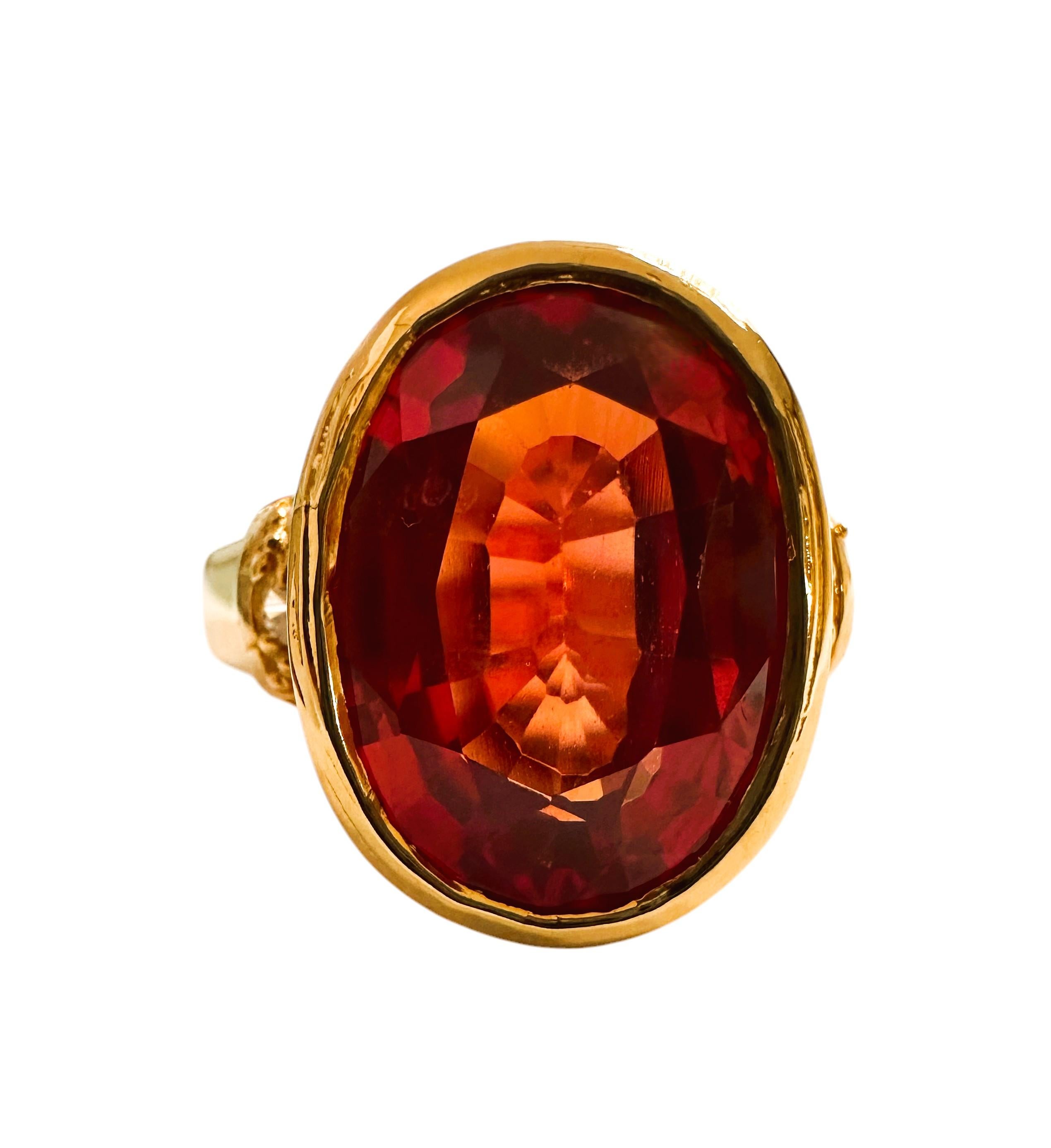 The stone is from Mozambique and is just exquisite. It is an Orange Sapphire and is 3.4 cts.  It is an fancy oval cut stone and measures 10 x 8 mm and has beautiful diamond cut White Sapphires flanking the stone on each side.  They are all set in a