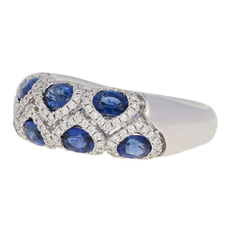 Illuminate the night with a scintillating touch of blue! Created by Spark in 18k white gold, this NEW ring features a majestic design of radiant sapphires individually framed by sparkling diamond halos.  

This ring is a size 6 1/4 - 6 1/2. Please