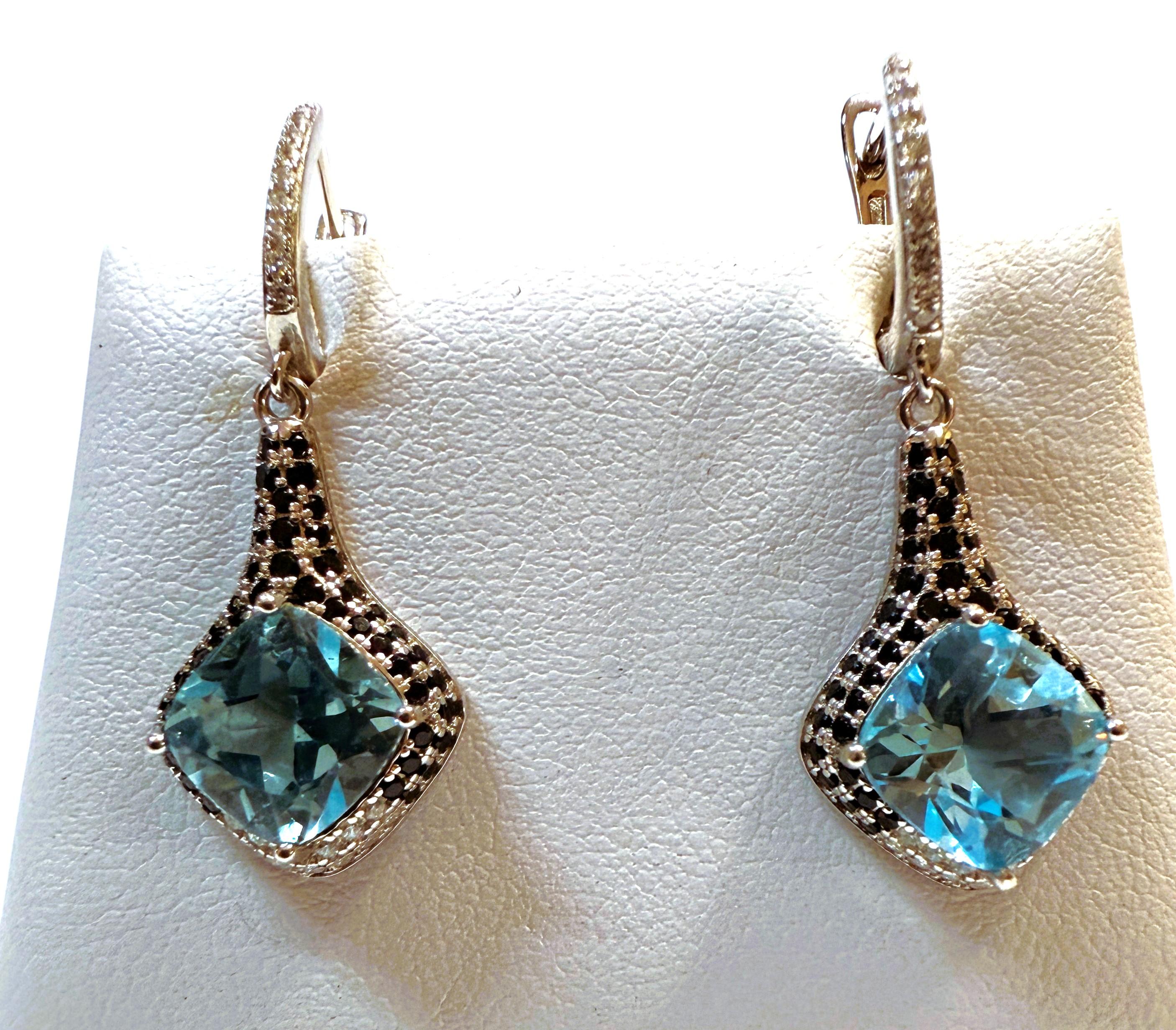 These earrings are just beautiful!  The stones are Cushion cut Blue Topaz Stones and each one is 2.04 carats, totaling 4.08 carats for both earrings.  Each stone measures 8 x 8 mm.  They are partly surrounded by diamond cut black spinels and on the