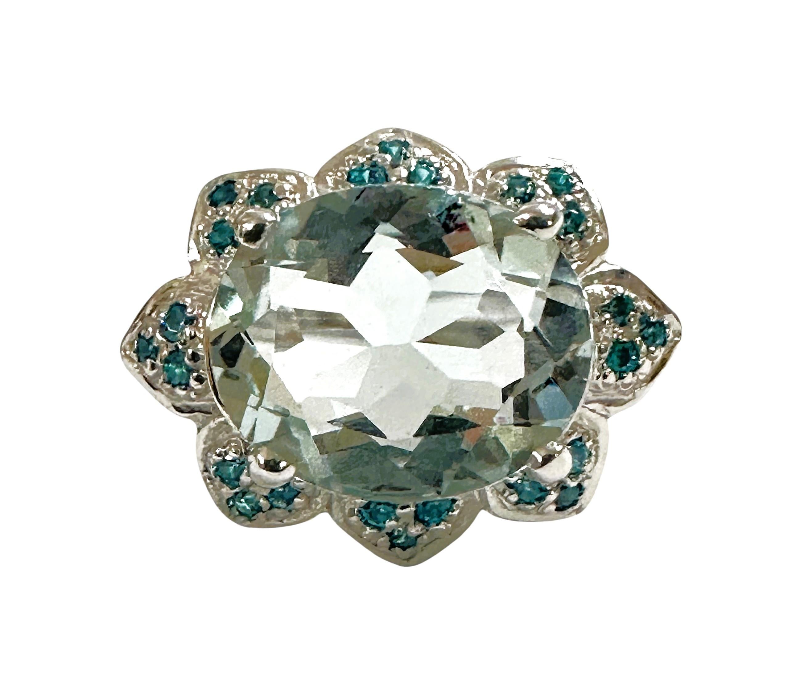 The stone is from Brazil and is just exquisite. The stone is an ice blue aquamarine and is 4.10 carats.  The stone is an oval cut stone and measures 12.2 x 10.2 mm and is surrounded by diamond cut Blue Pariaba stones which really compliments the