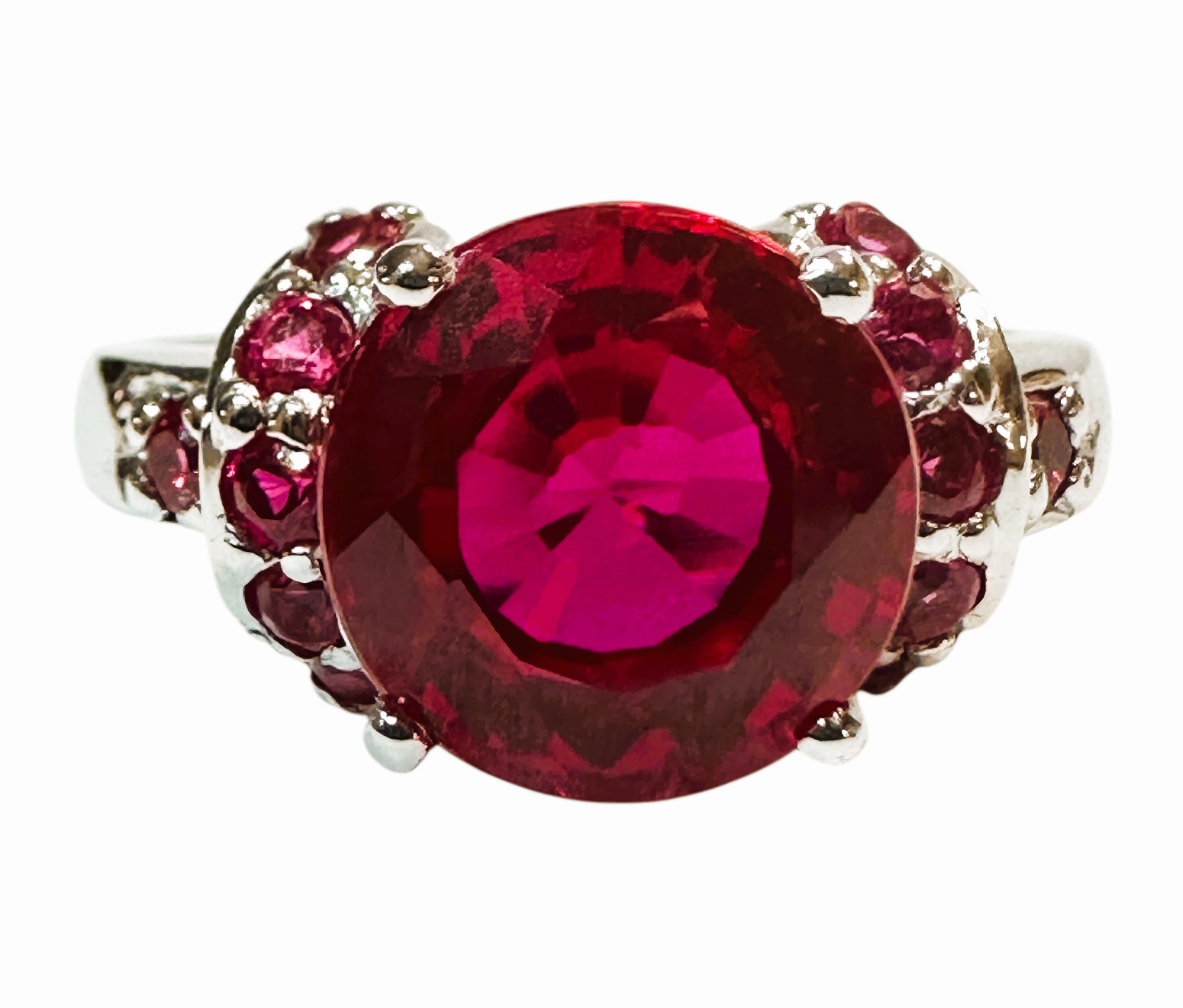 What a gorgeous ring!  The ring is a size 6.75.  The stone is from Africa and is just exquisite.  It is a round cut stone and is 4.50 Carats.   The main stone is 9 mm round and is flanked by diamond cut red sapphires on either side of the band.  The