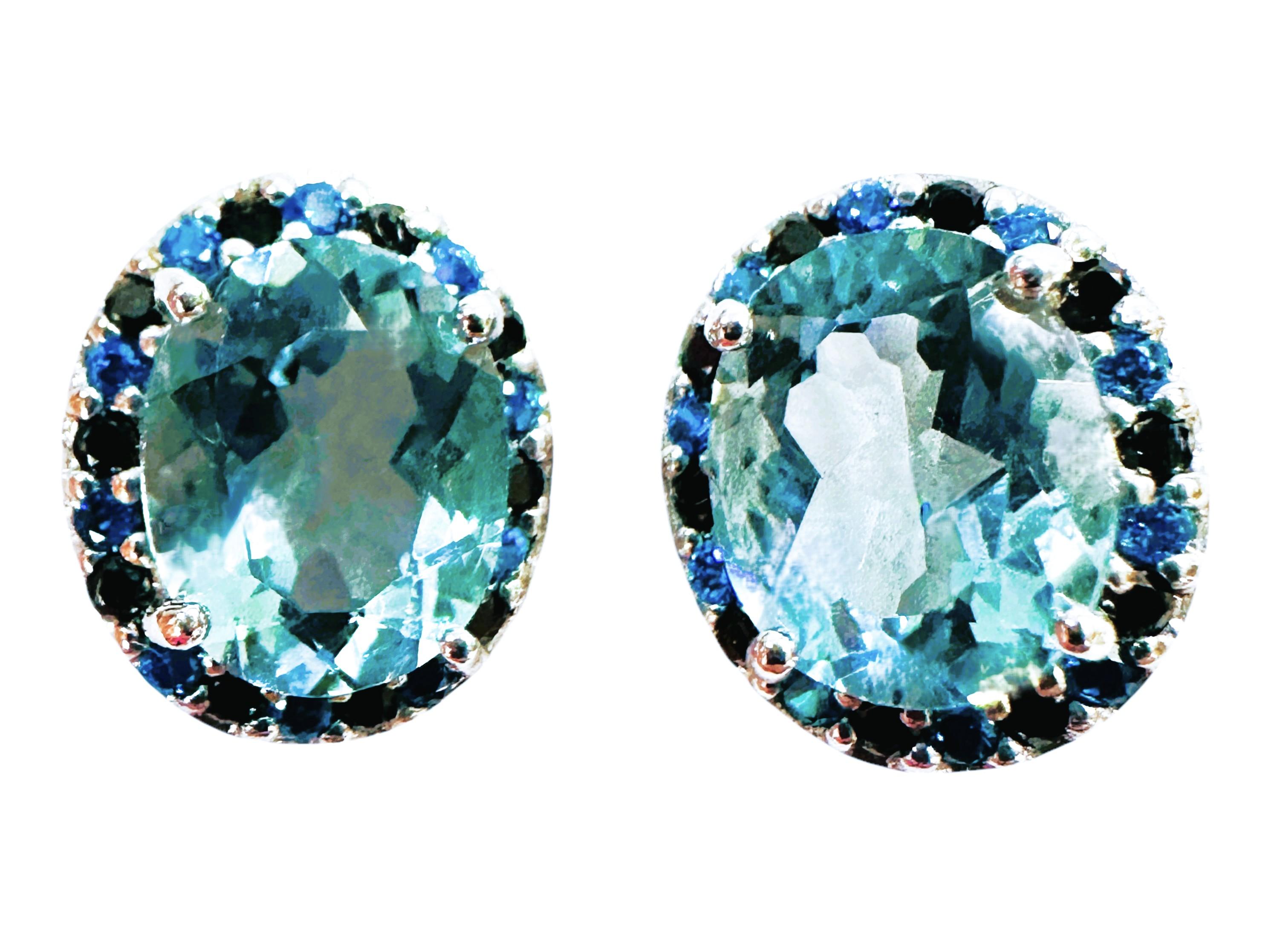 These earrings are just beautiful!  The stones are from Brazil.  The stones are a fancy oval cut and total 5.0 carats.  The stones measure 10 x 8 mm and are surrounded by diamond cut aqua sapphires and diamond cut black spinels.  All the stones are