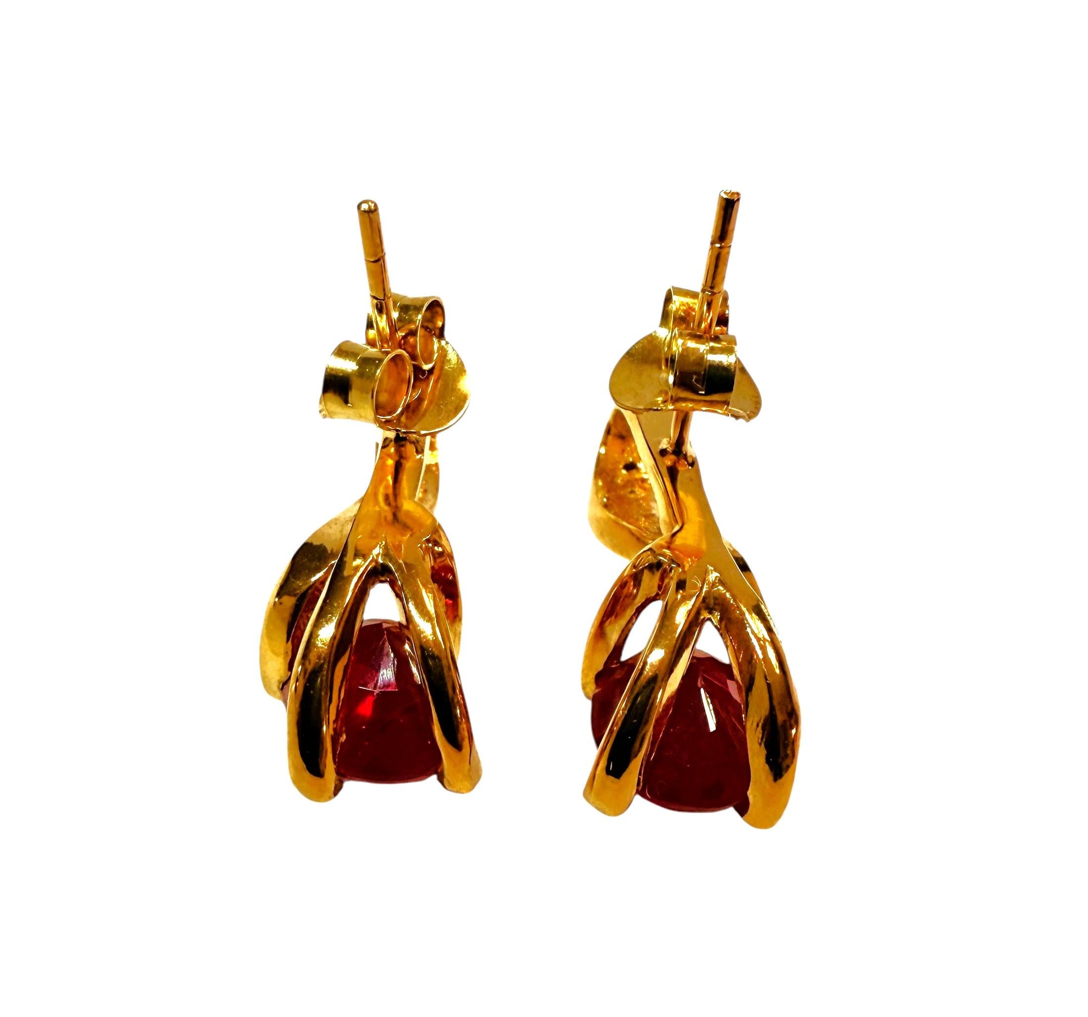 I just love the design of these earrings. There is a beautiful oval cut Red Sapphire stone on the earrings, and each one is 2.5 carats.  They measure 9 x 7 mm.  They are from Africa and is just exquisite.  They are very high-quality stones.  And