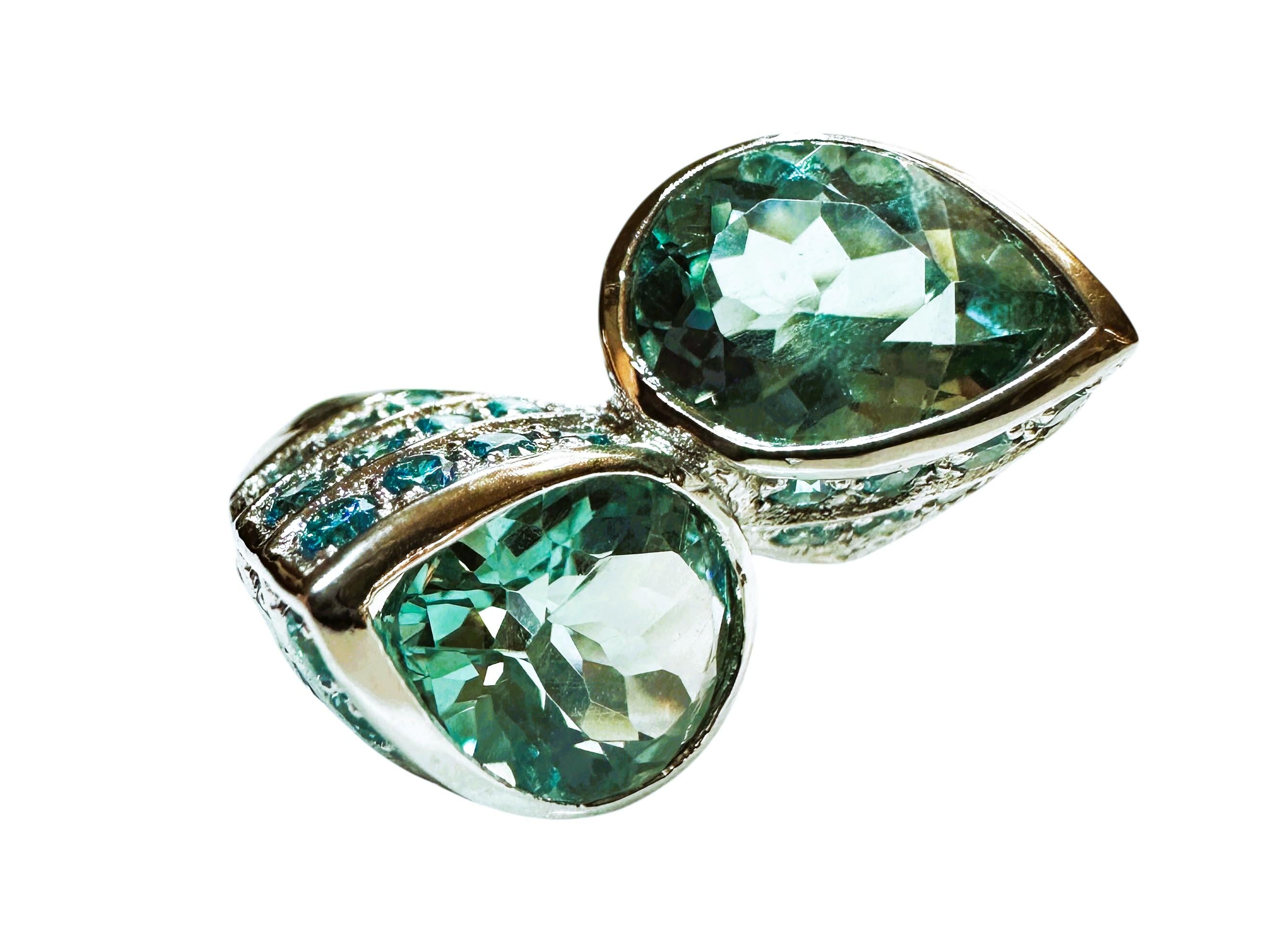 The ring is just stunning!  It is a size 6. The two Aquamarine stones are from Brazil.  They are beautiful pear cut stones and each are 3.05 cts and total 6.1 cts.  They are very high quality stones. They measure 9 x 11 mm and they are surrounded by
