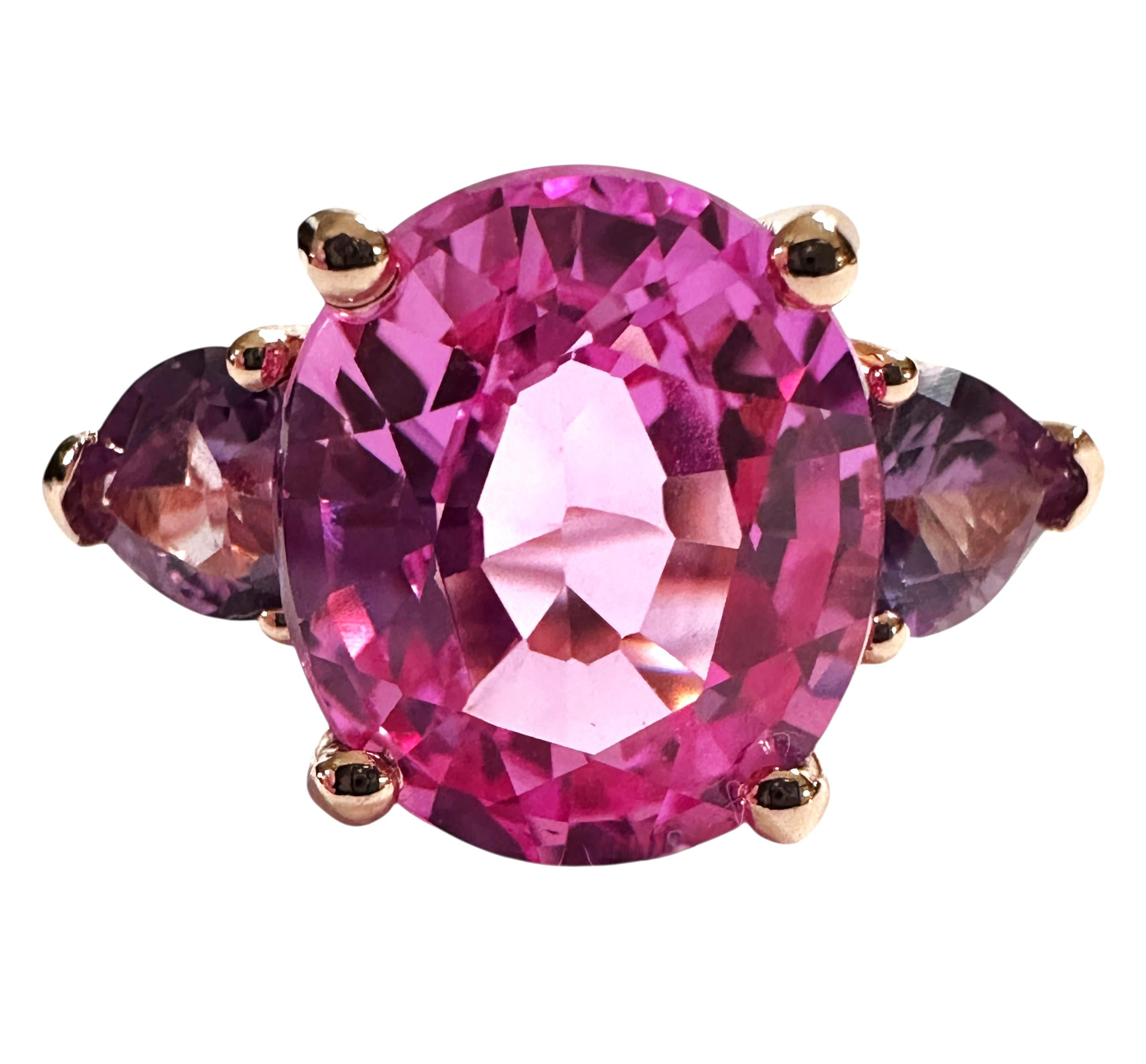 The stone is from Sri Lanka and is just exquisite. The stone is a Pink Sapphire and is 6.95 carats.  The stone is a fancy oval cut stone and measures 12 x 10.2 mm and has a heart cut purple alexandrite on either side. They are all placed in a