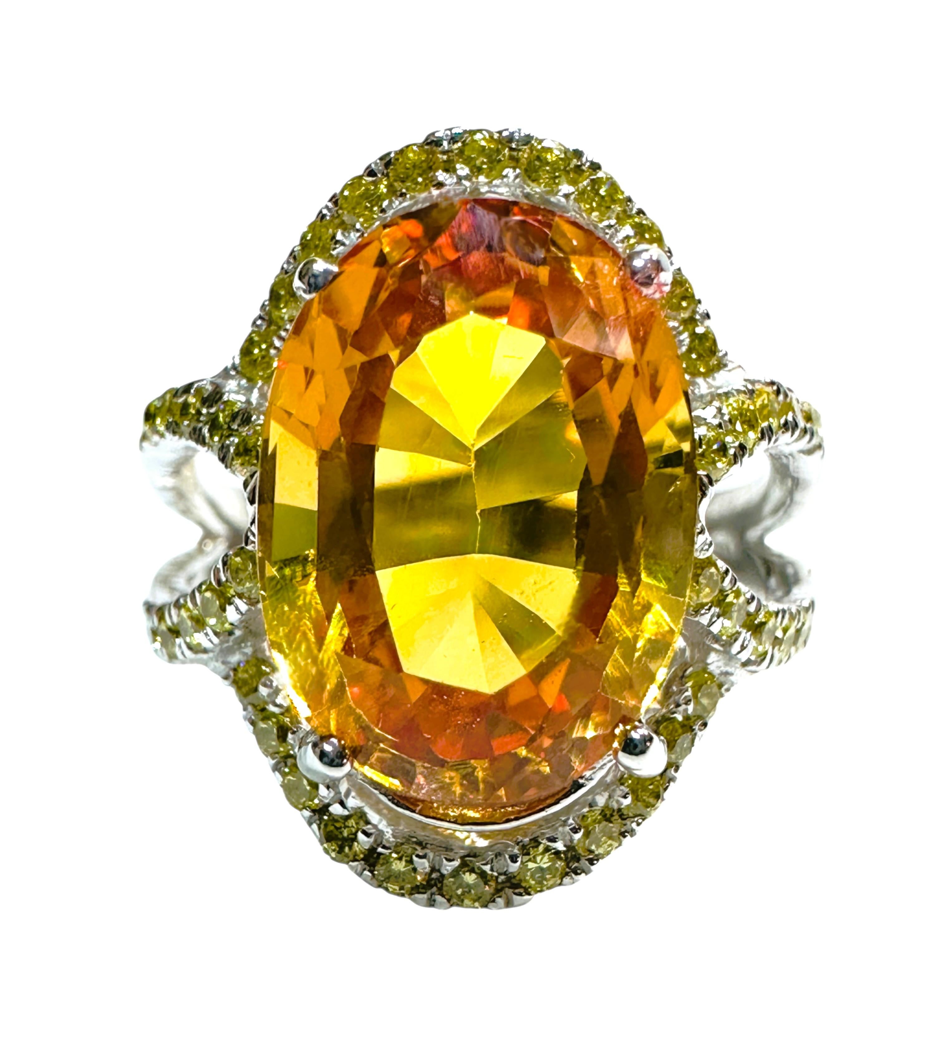 This is a very fetching ring.  This stone is from Sri Lanka and just a beautiful shade of yellow..  It has a bit of orange in it.  The ring is a size 6.25.   It is a fancy oval cut stone and is 13 x 9.5 mm and is surrounded by diamond cut yellow