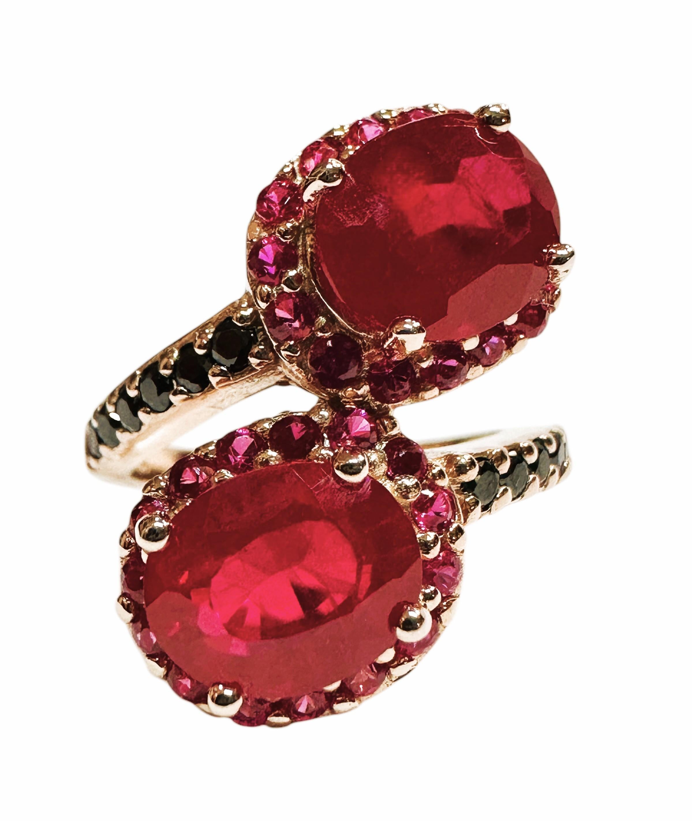 The ring is just stunning!  It is a size 6.25. The two Red Sapphires are from Madagascar.  They are beautiful fancy cut oval stones and each are 3.80 cts and total 7.65 cts.  They are very high quality stones. They measures 9 x 7.3 mm and they are